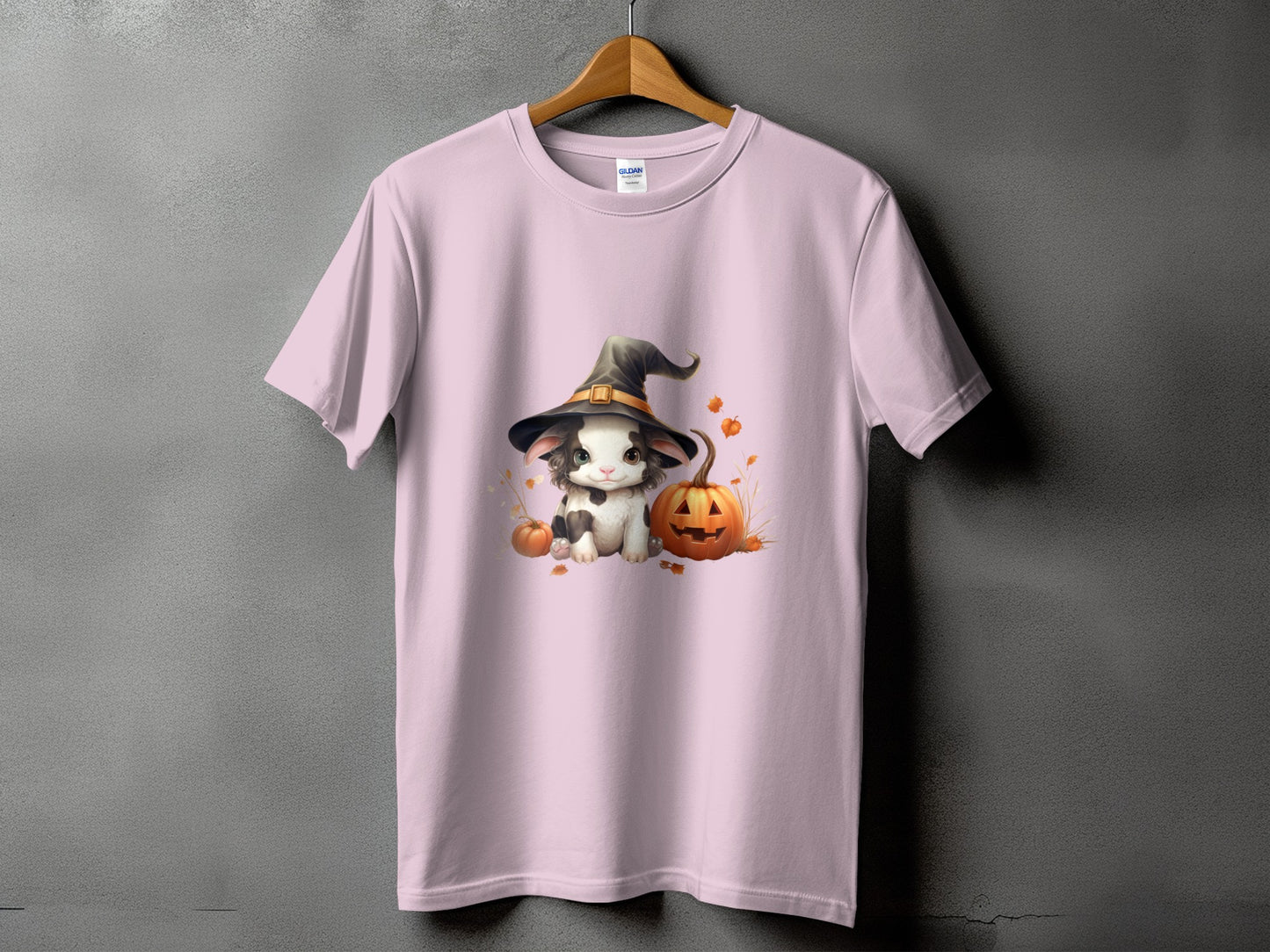 Pink t-shirt with graphic of a bunny wearing a witch hat and pumpkins.