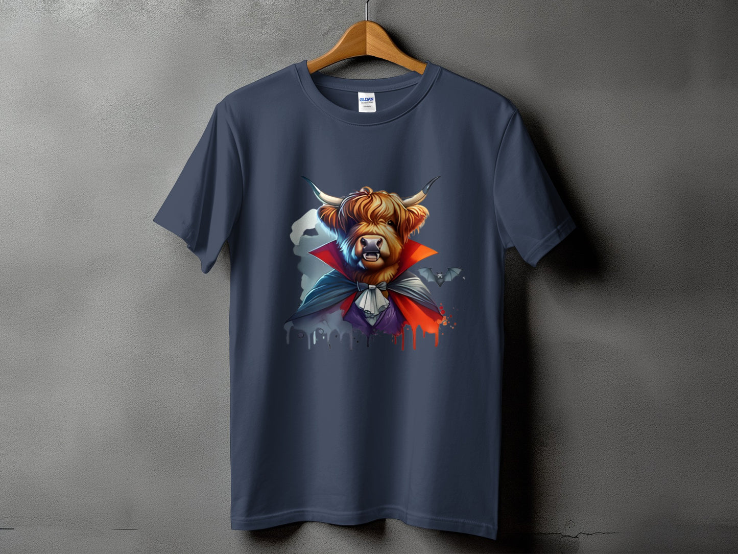Highland cow wearing a vampire cape with bats and dripping paint graphic on t-shirt.