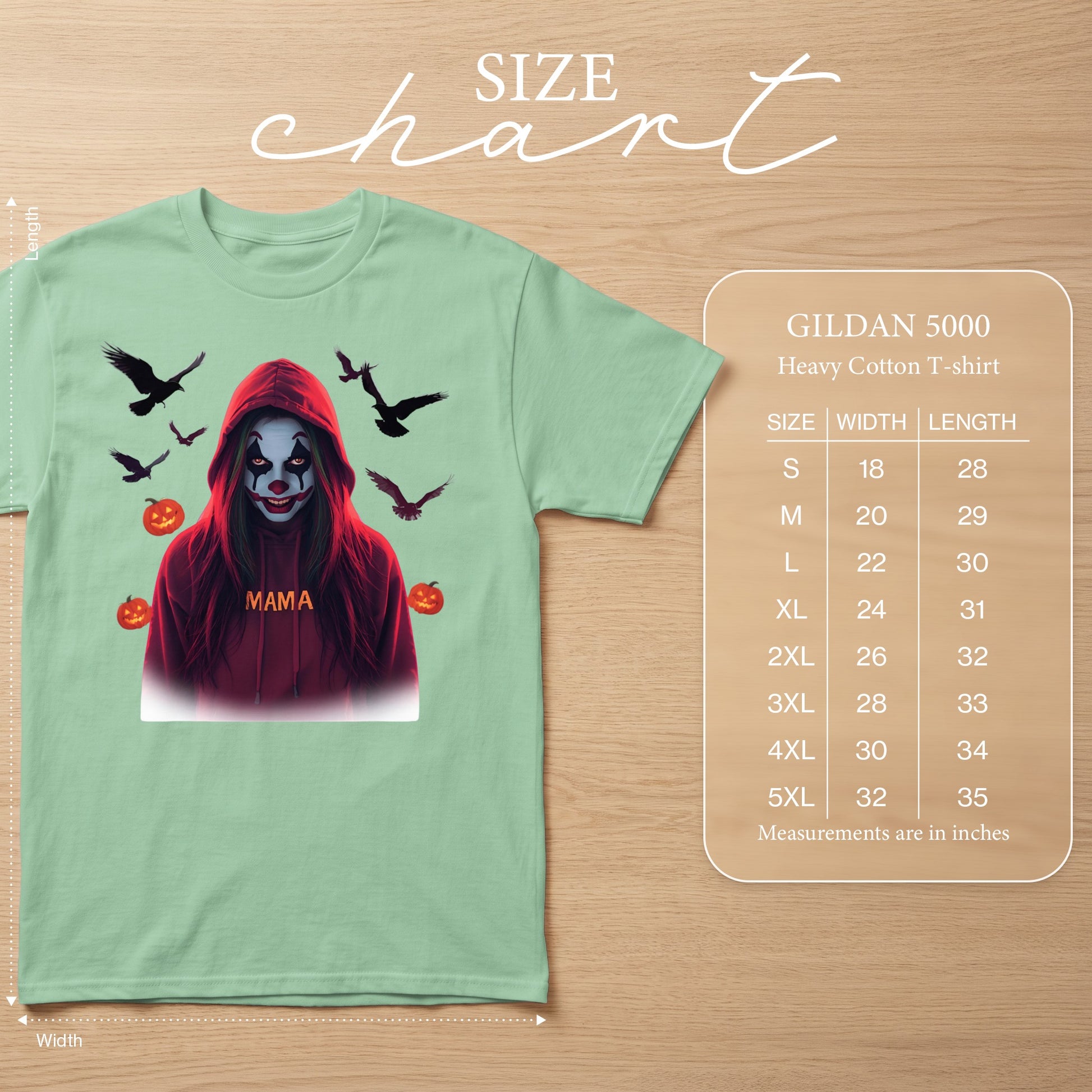 Light green t-shirt with a clown graphic, birds, and pumpkins. Size chart shown.