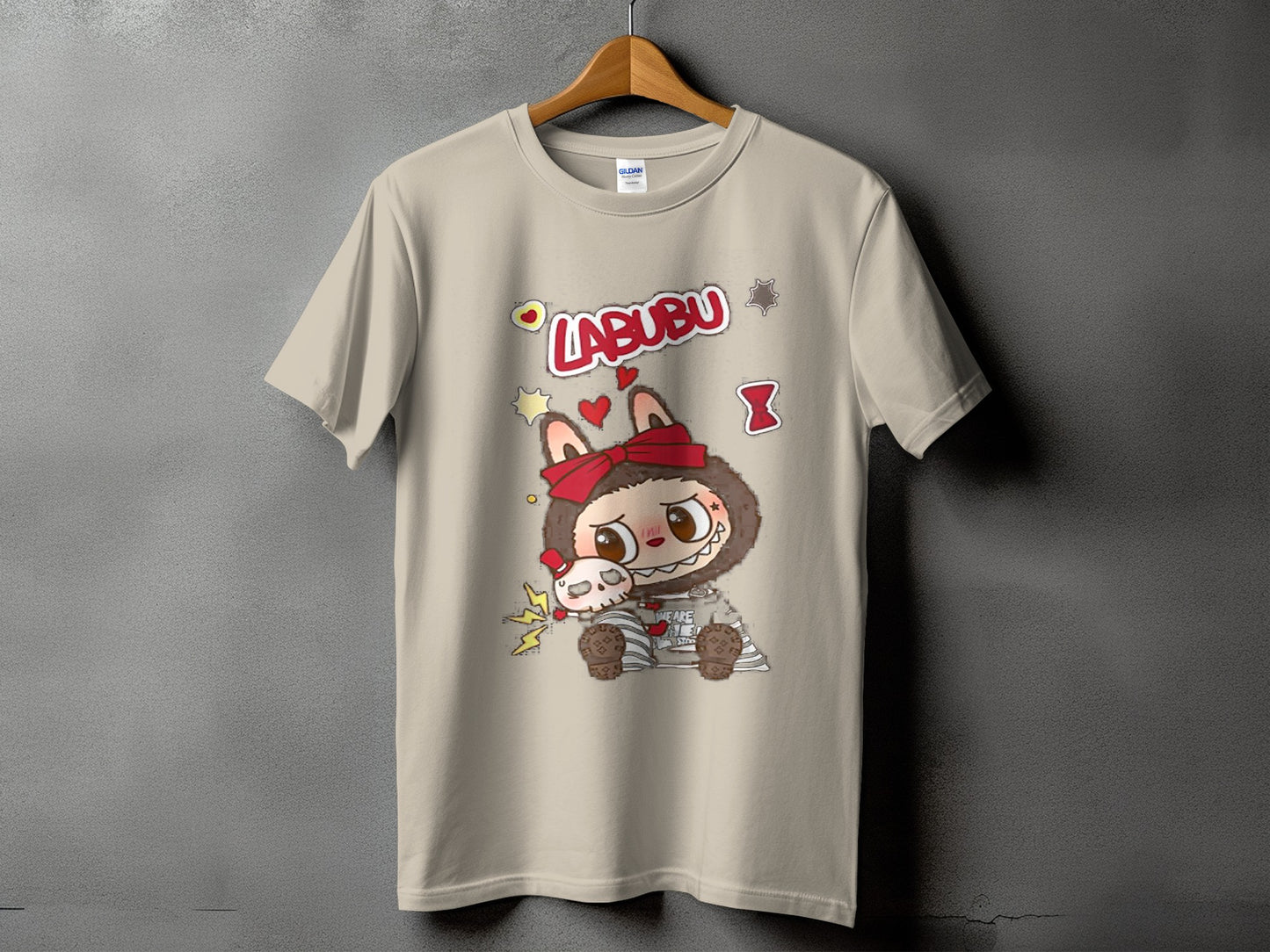Labubu character on a tan t-shirt with red bow and hearts graphic.