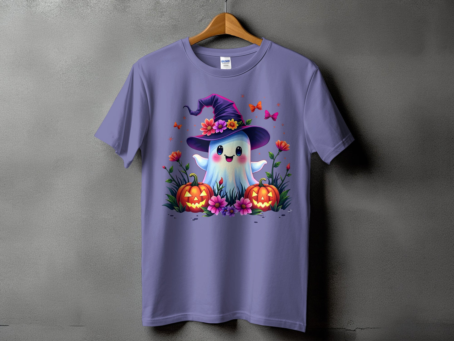 Purple t-shirt with a happy ghost wearing a witch hat and surrounded by pumpkins and flowers.