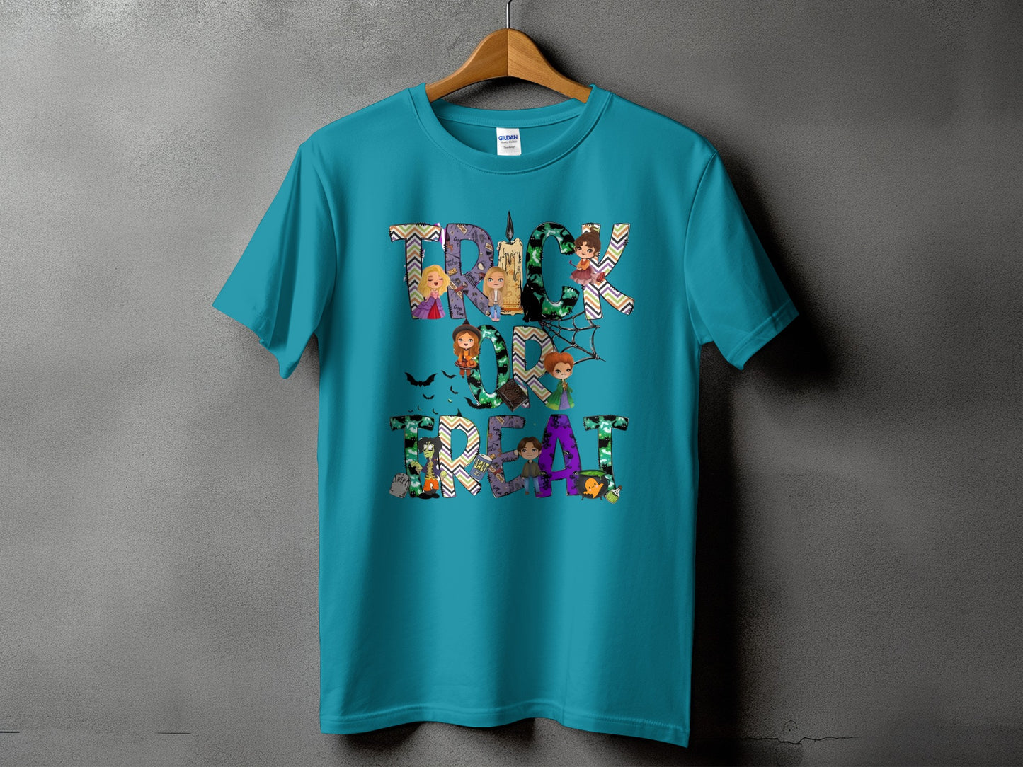 Teal t-shirt with "Trick or Treat" text featuring Halloween characters and patterns.