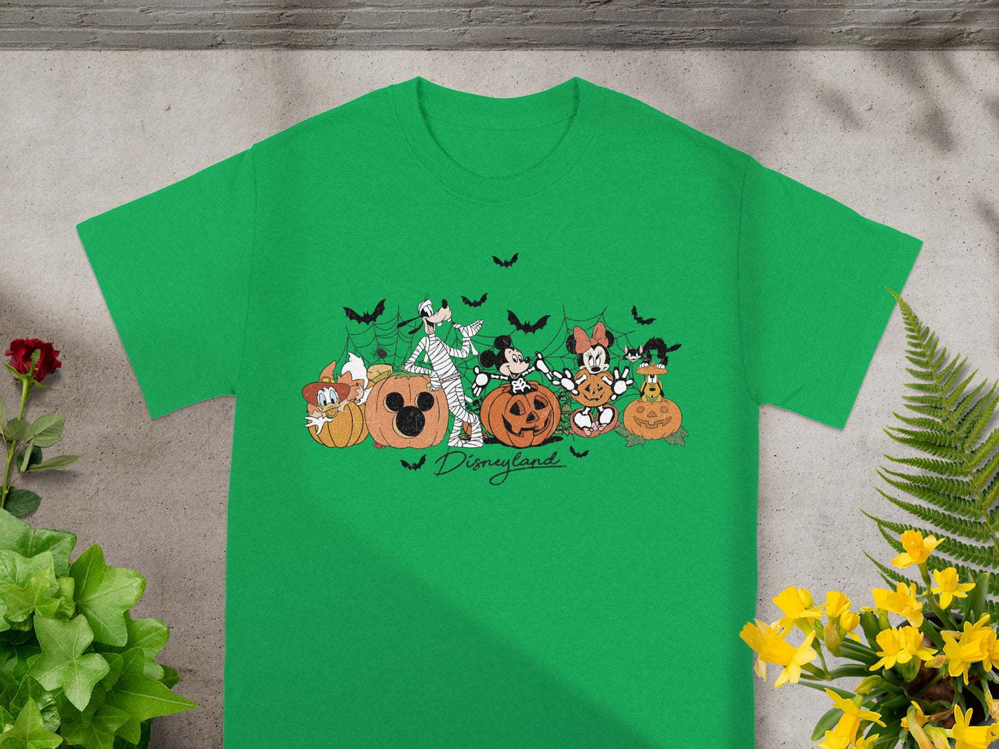 Green t-shirt with Mickey Mouse characters, pumpkins, and bats, reading "Disneyland".