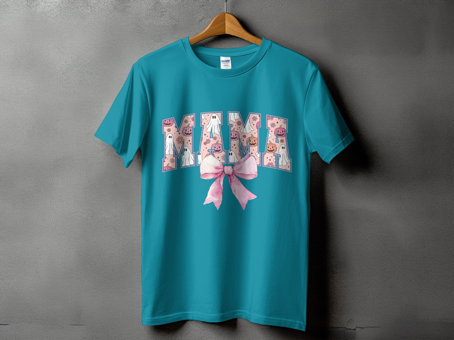 Teal t-shirt with "Mama" text filled with Halloween ghosts and pumpkins.