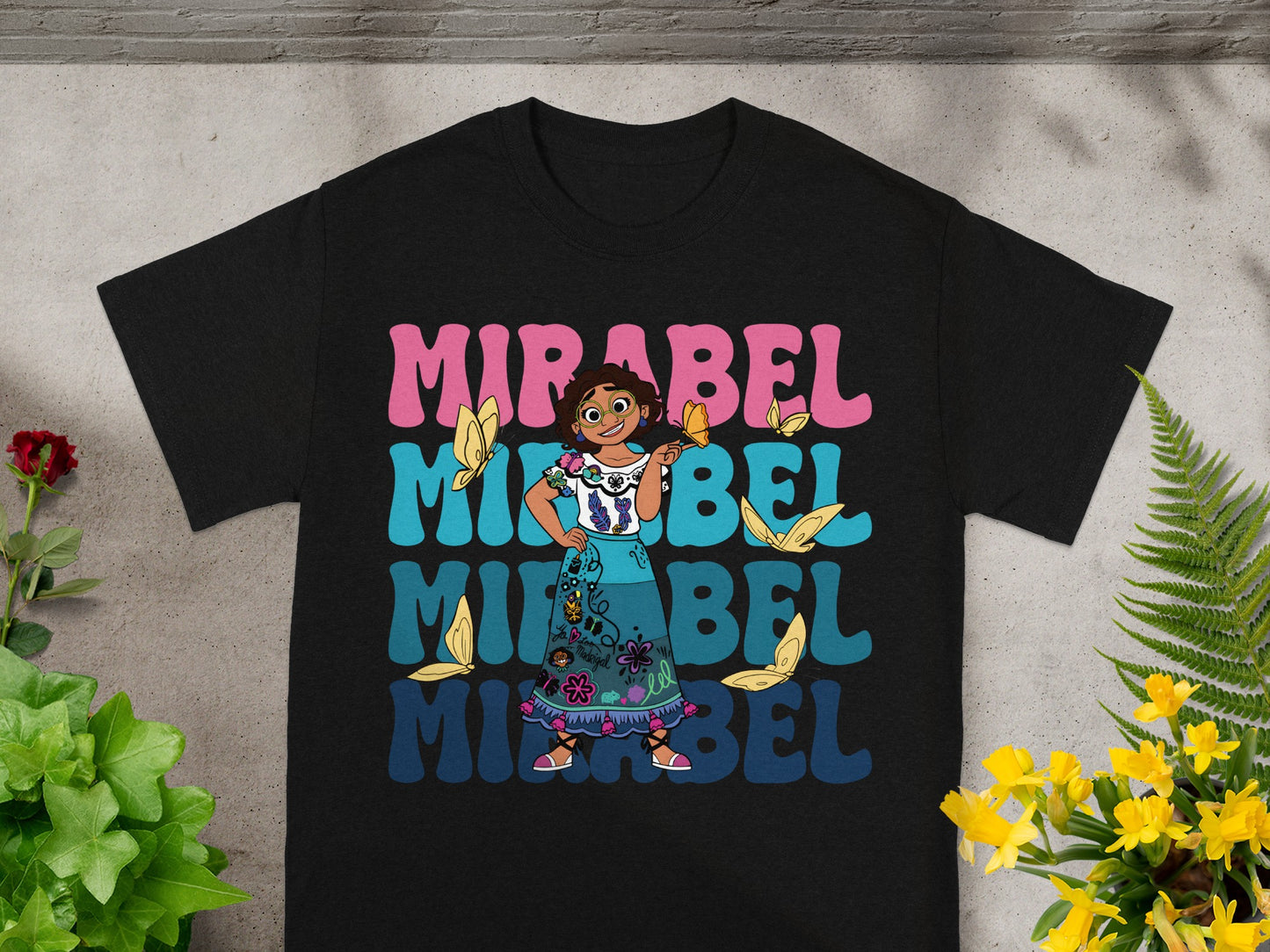 Black t-shirt with Mirabel Madrigal from Encanto and colorful "Mirabel" text.
