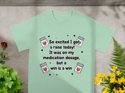 Mint green t-shirt with "So excited I got a raise today! It was on my medication dosage, but a win is a win" text.