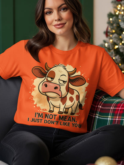 Orange t-shirt with cartoon cow saying "I'm not mean, I just don't like you."