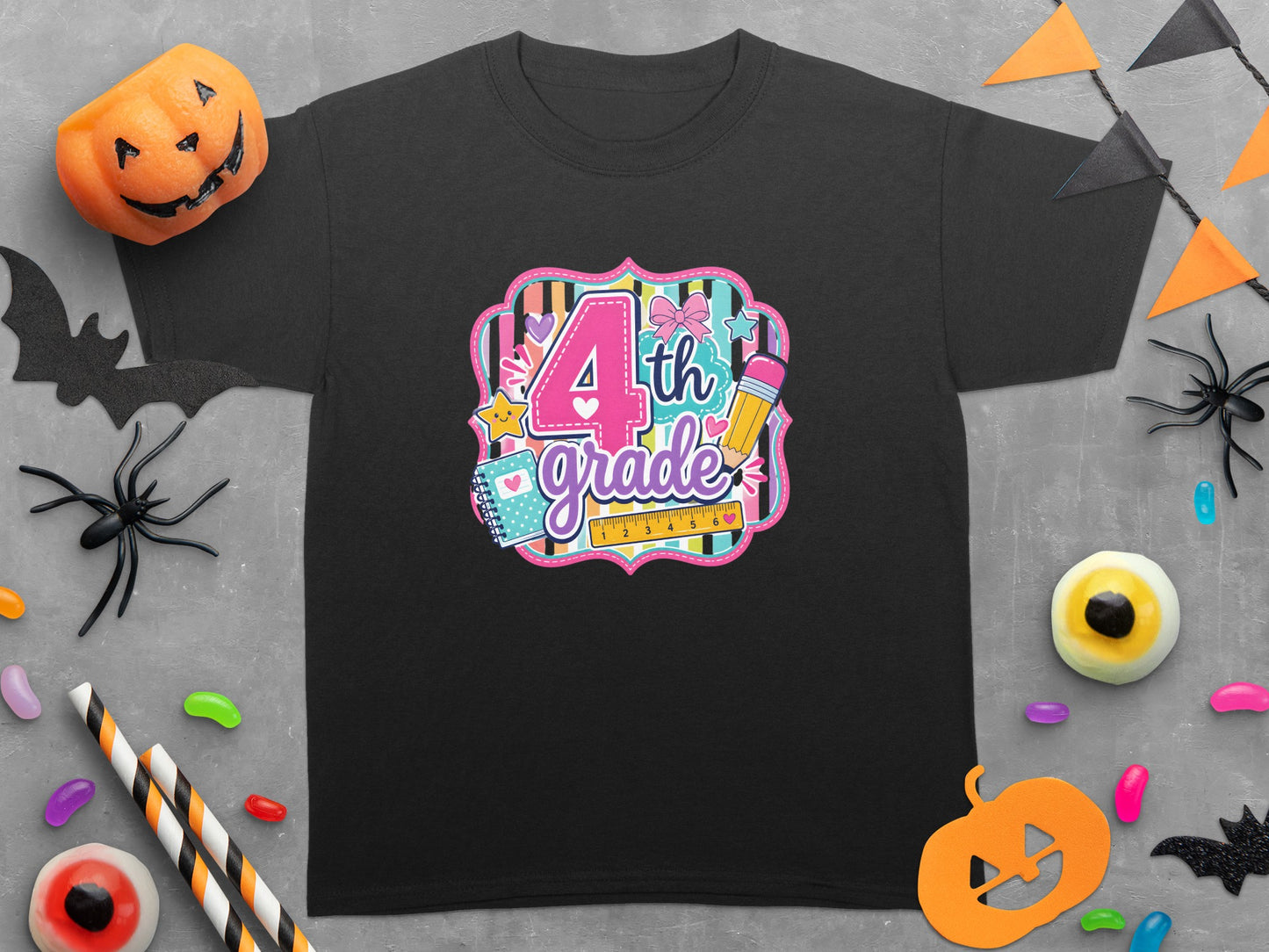 Black t-shirt with "4th grade" text, glitter, hearts, and school supplies graphic.