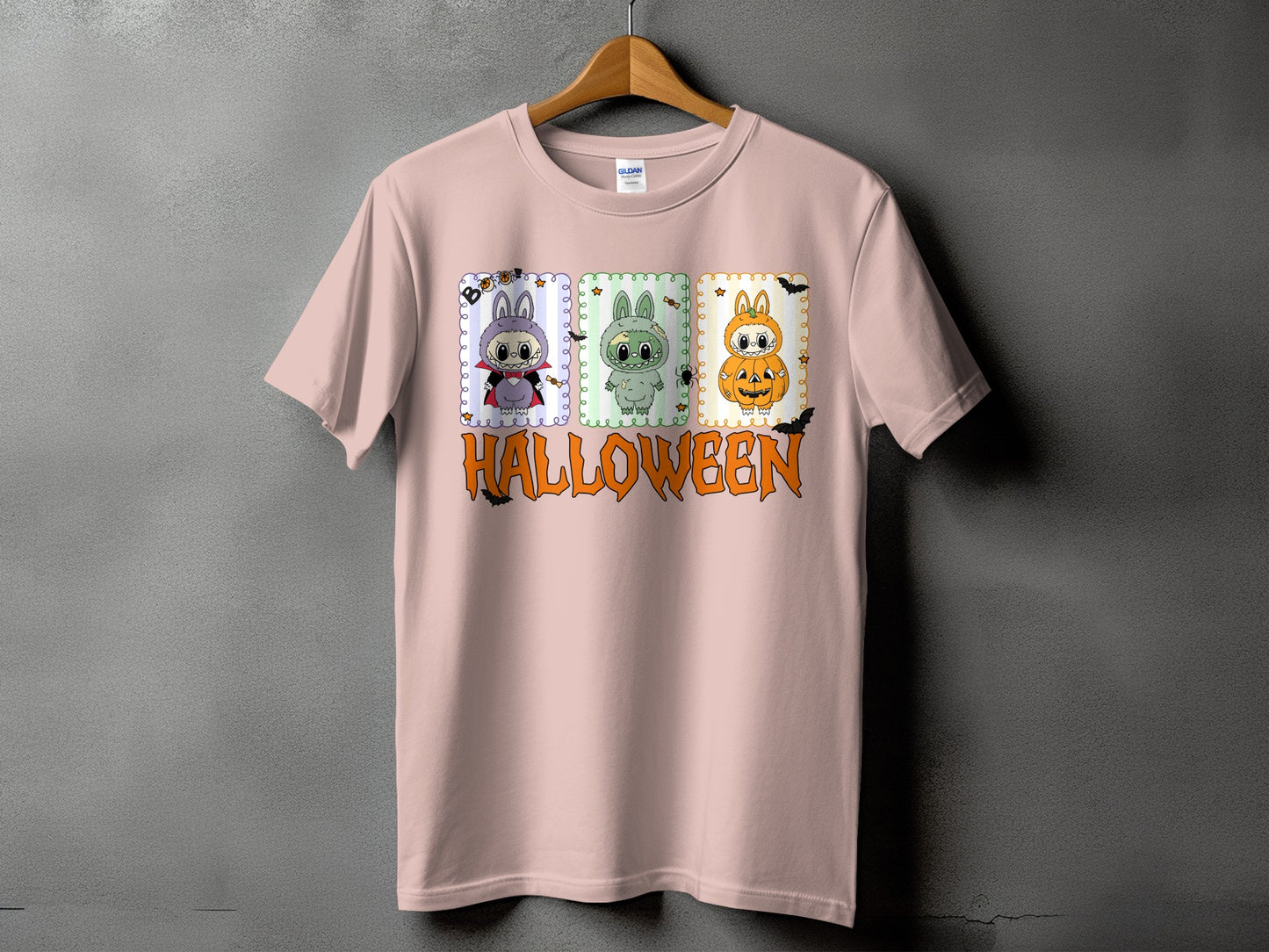 Pink t-shirt with three Halloween-themed cartoon characters and "HALLOWEEN" text.