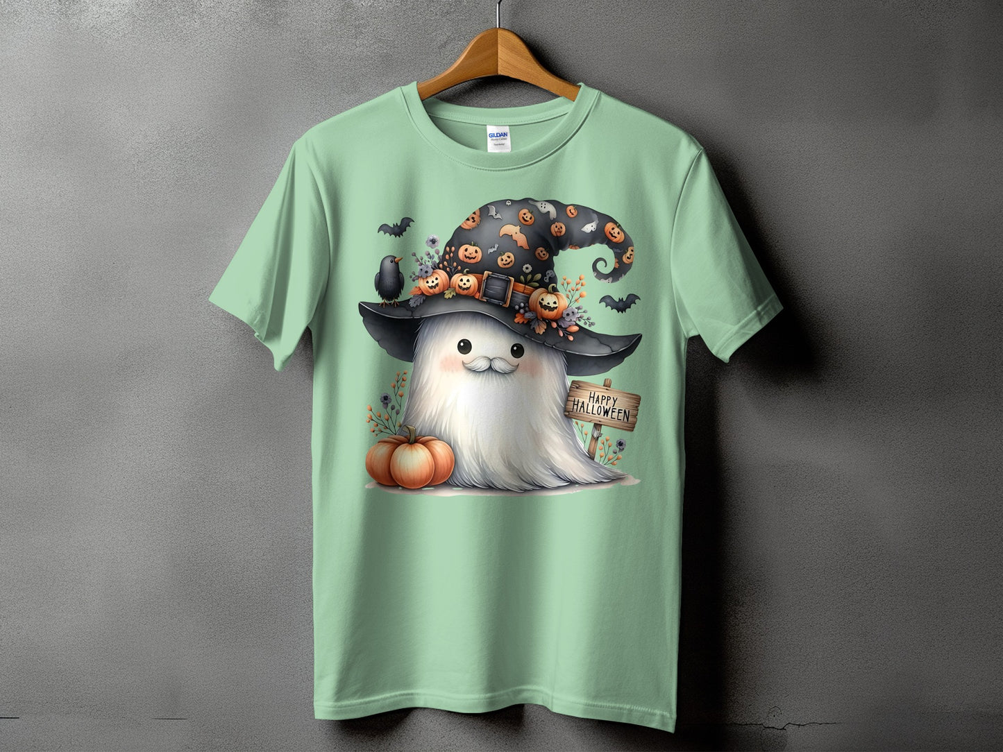 Light green t-shirt with a cute ghost wearing a witch hat and a "Happy Halloween" sign.