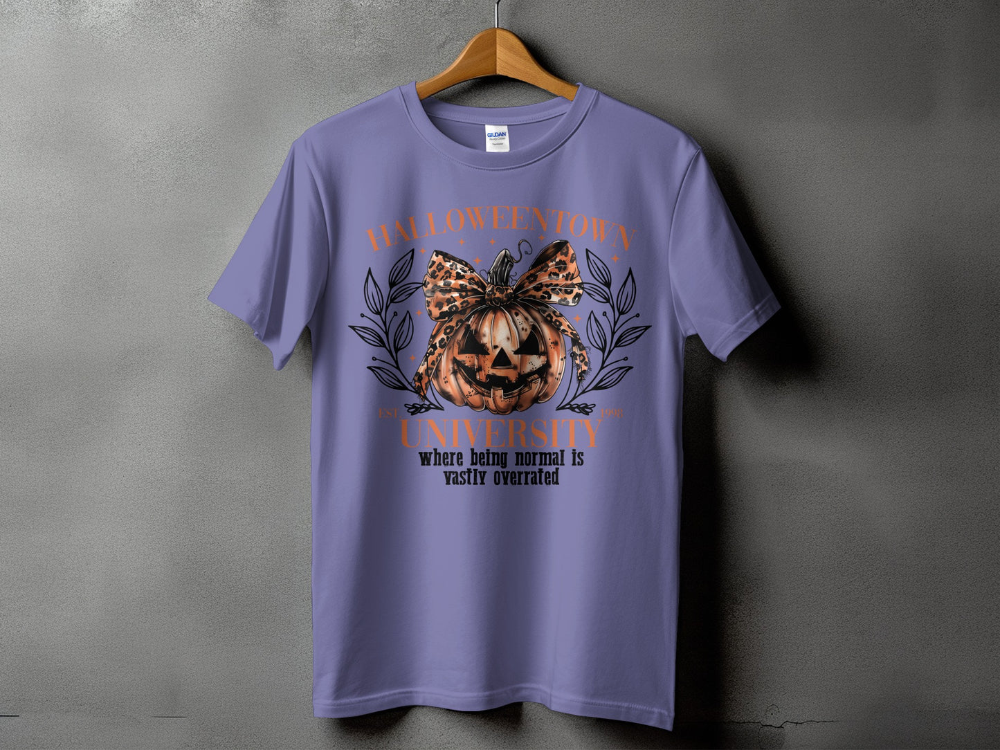 Purple t-shirt with "Halloweentown University" graphic featuring a pumpkin and leopard print bow.