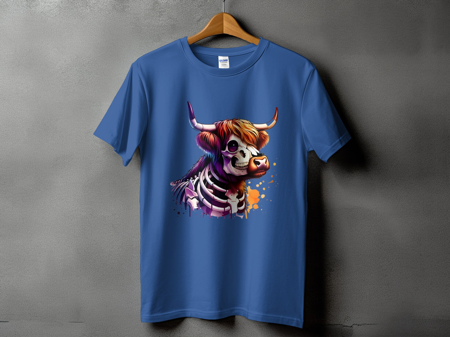 Blue t-shirt with a skeleton highland cow graphic and colorful paint splatters.