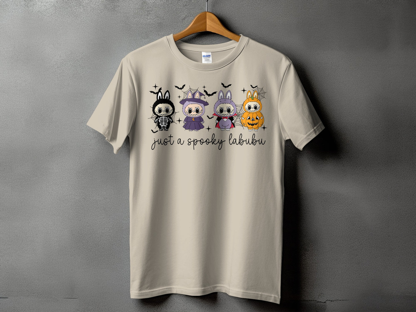 T-shirt with four cute cartoon characters in Halloween costumes and "just a spooky labubu" text.