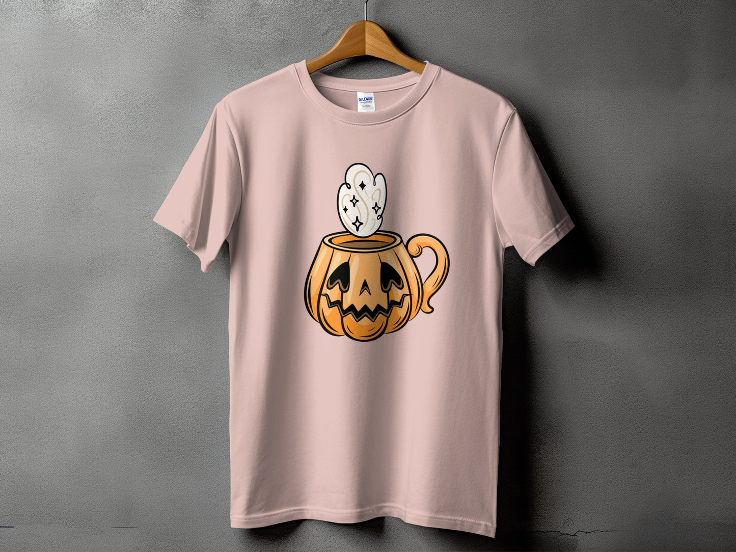 Pink t-shirt with a jack-o'-lantern mug graphic and steam.