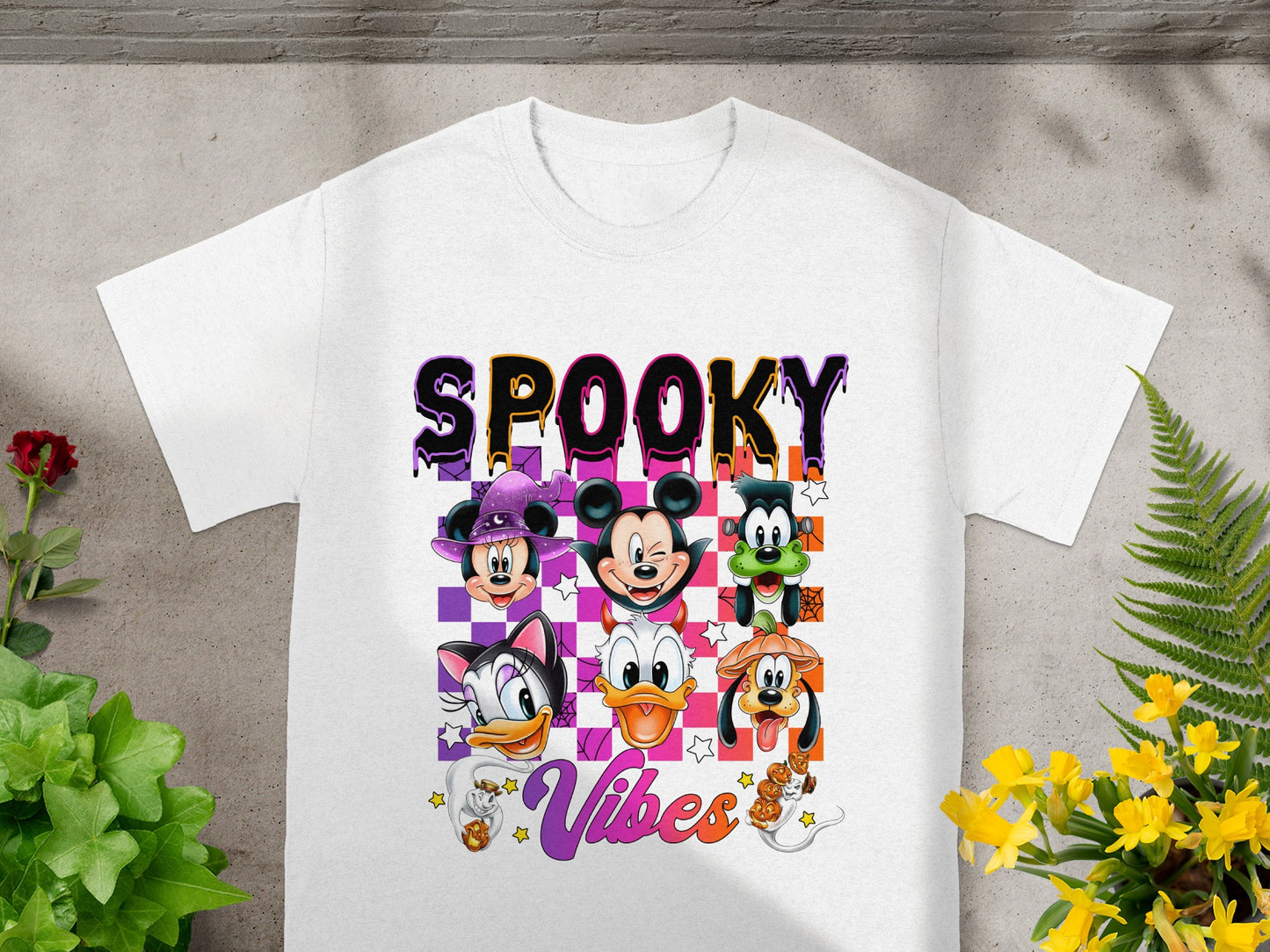 White t-shirt with "SPOOKY Vibes" text and Disney characters in Halloween costumes.