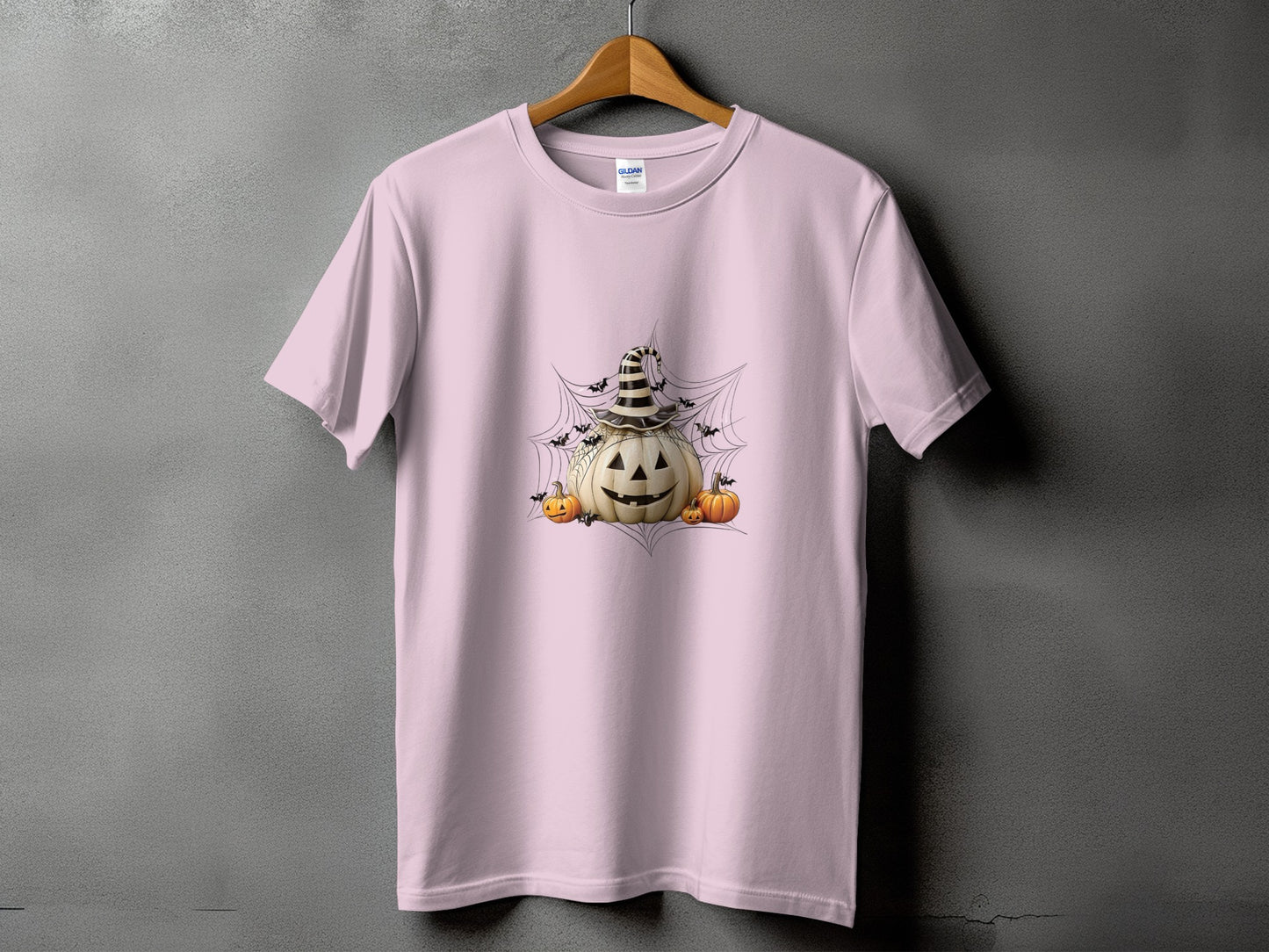 Pink t-shirt with jack-o'-lantern, pumpkins, bats, and cobweb graphic.