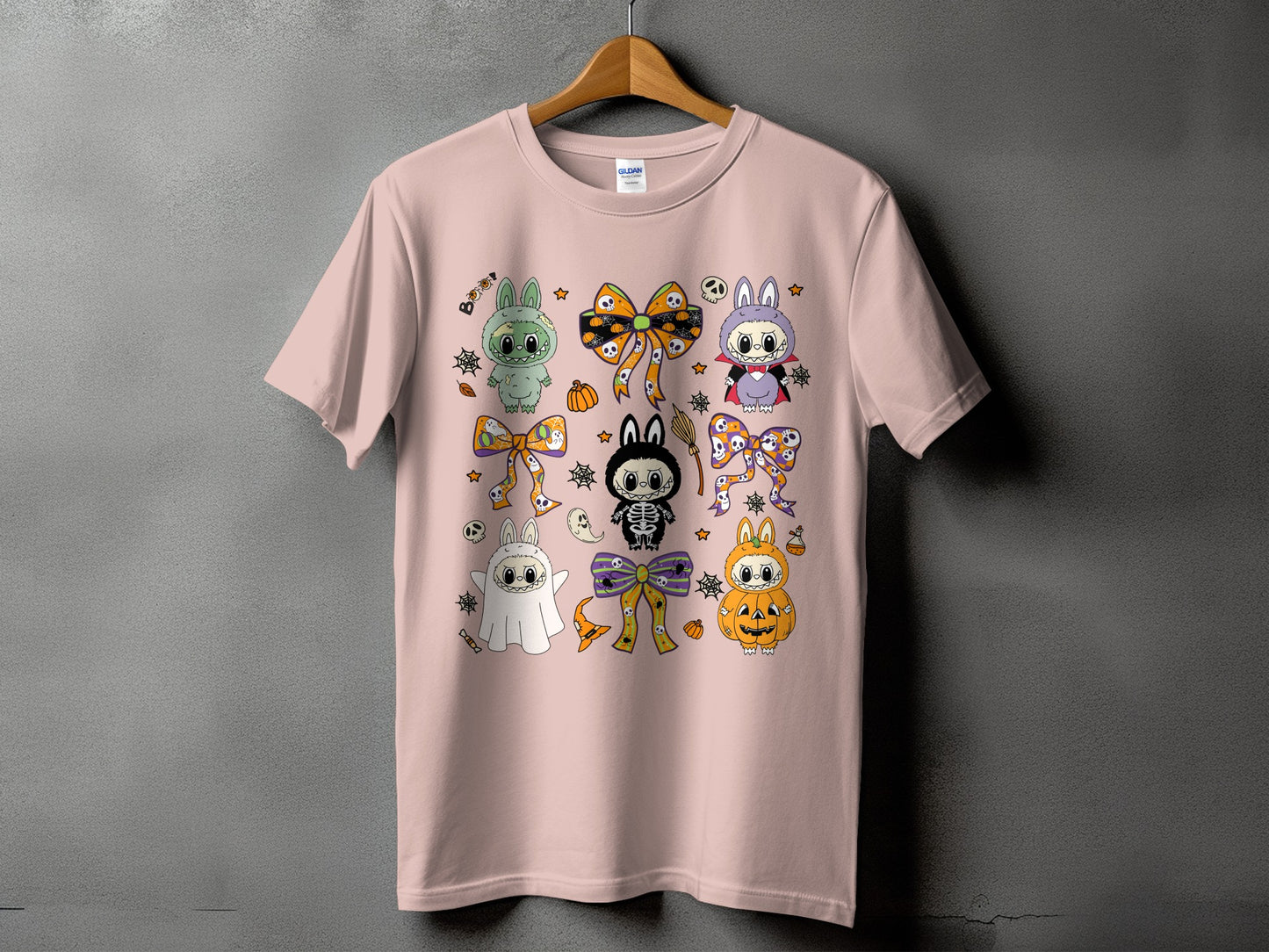Pink t-shirt with assorted cute Halloween-themed cartoon characters and bows.