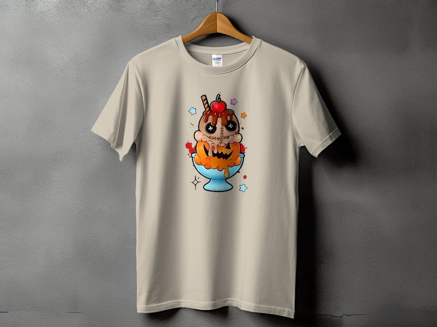 Tan t-shirt with a stitched doll-like ice cream sundae and pumpkin graphic.