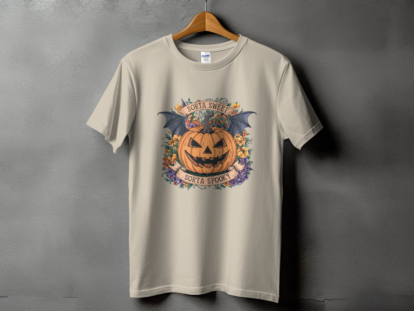 Light beige t-shirt with Halloween pumpkin, bat wings, and text.