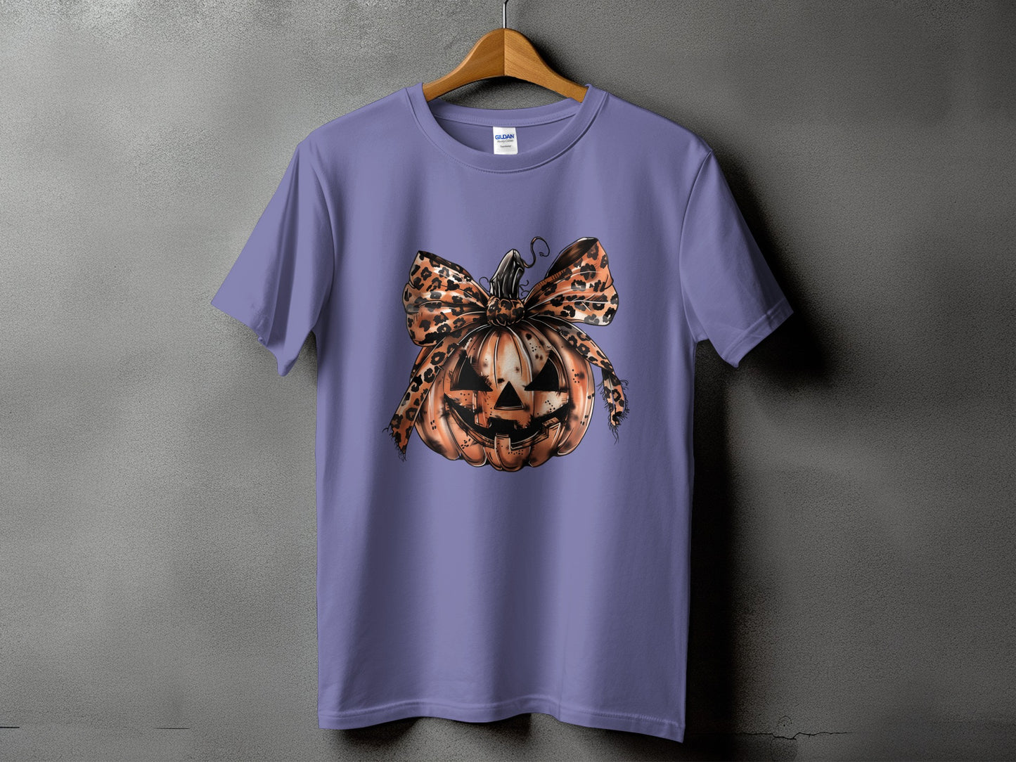 Purple t-shirt with a distressed jack-o'-lantern and leopard print bow graphic.