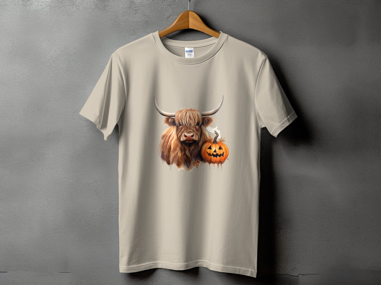 Tan t-shirt with a Highland cow and jack-o'-lantern graphic.