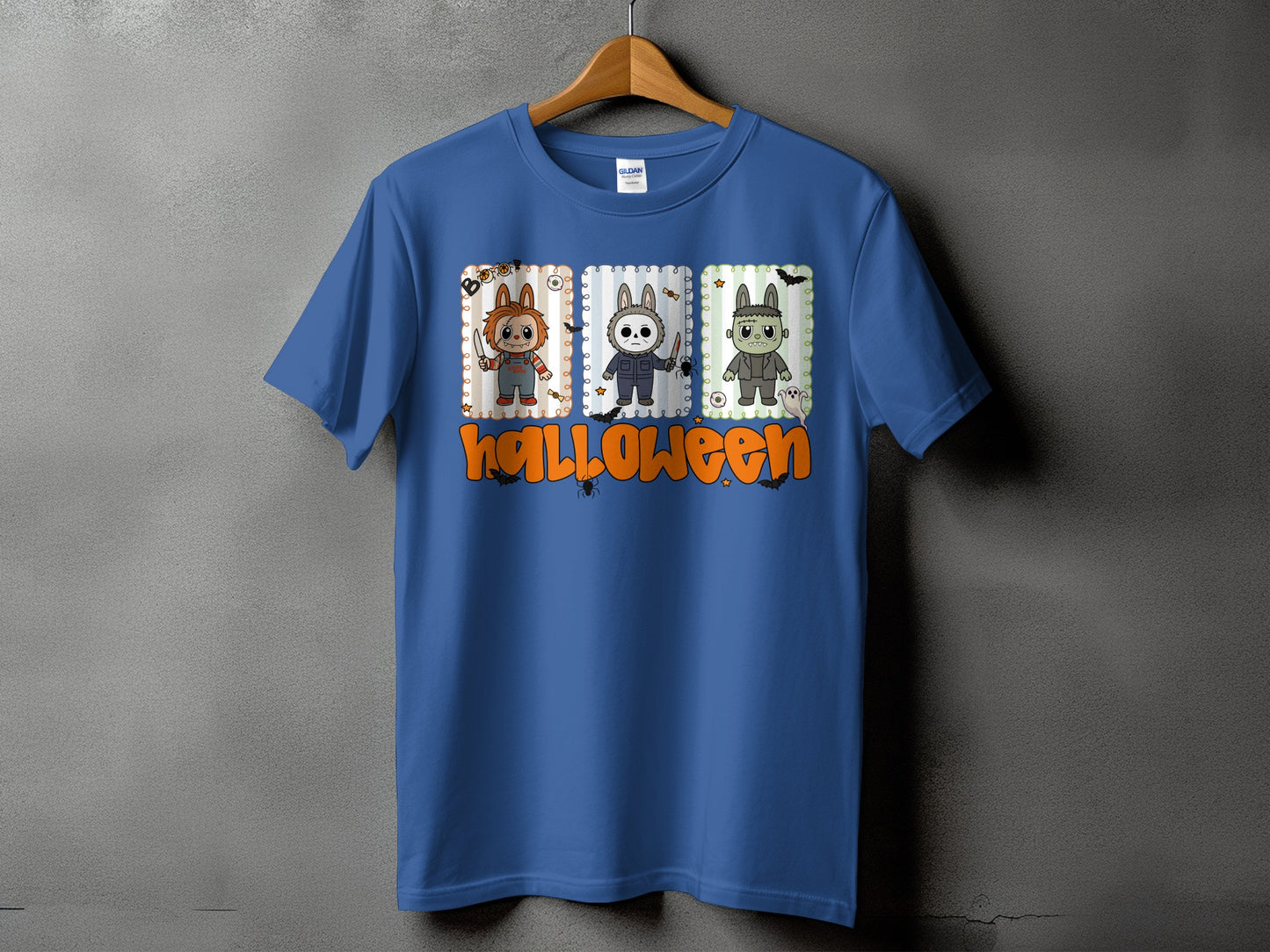 Blue t-shirt with Halloween graphic of cartoon horror characters and text.