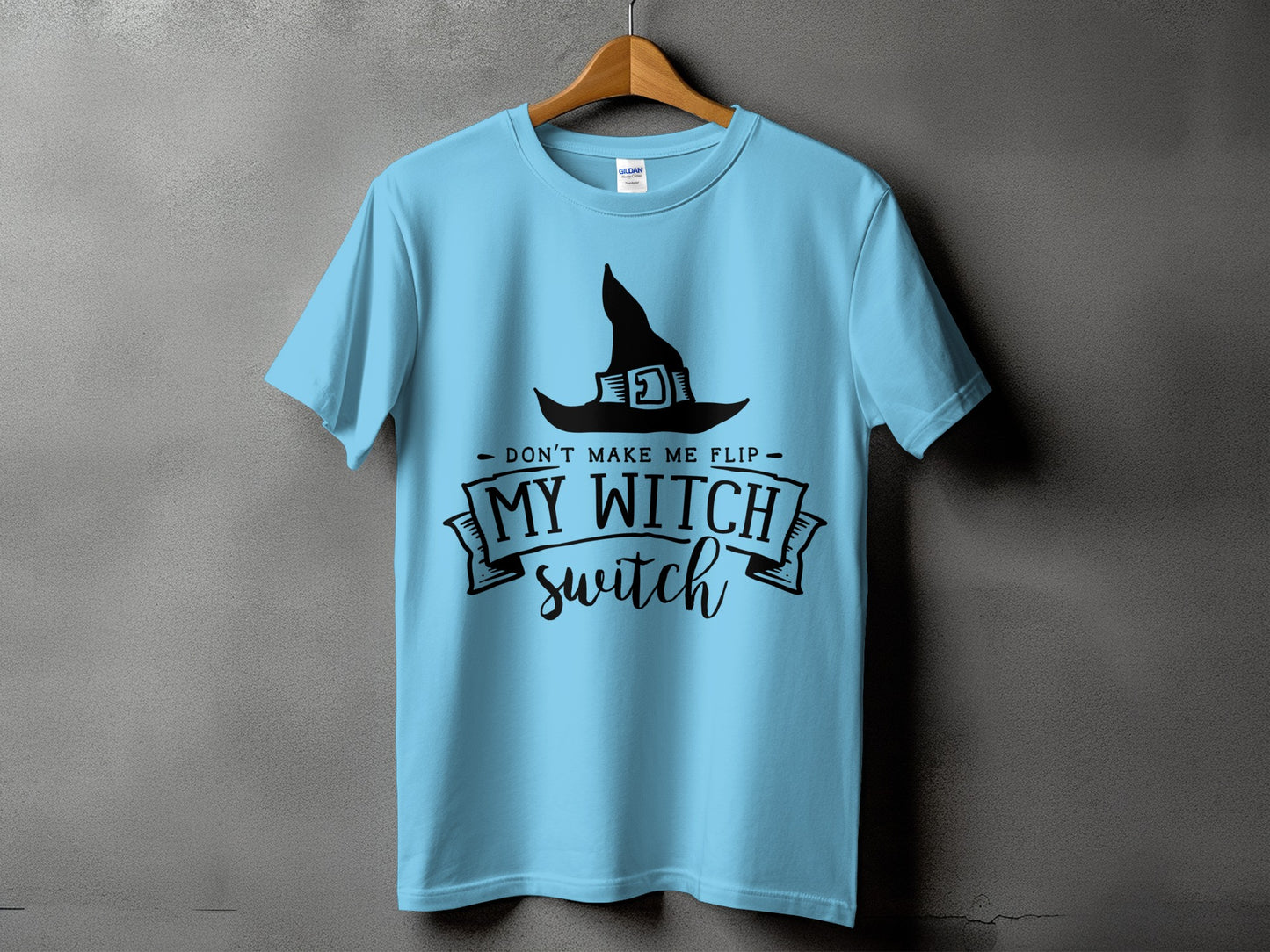 Light blue t-shirt with black witch hat and text: "Don't make me flip My Witch switch"