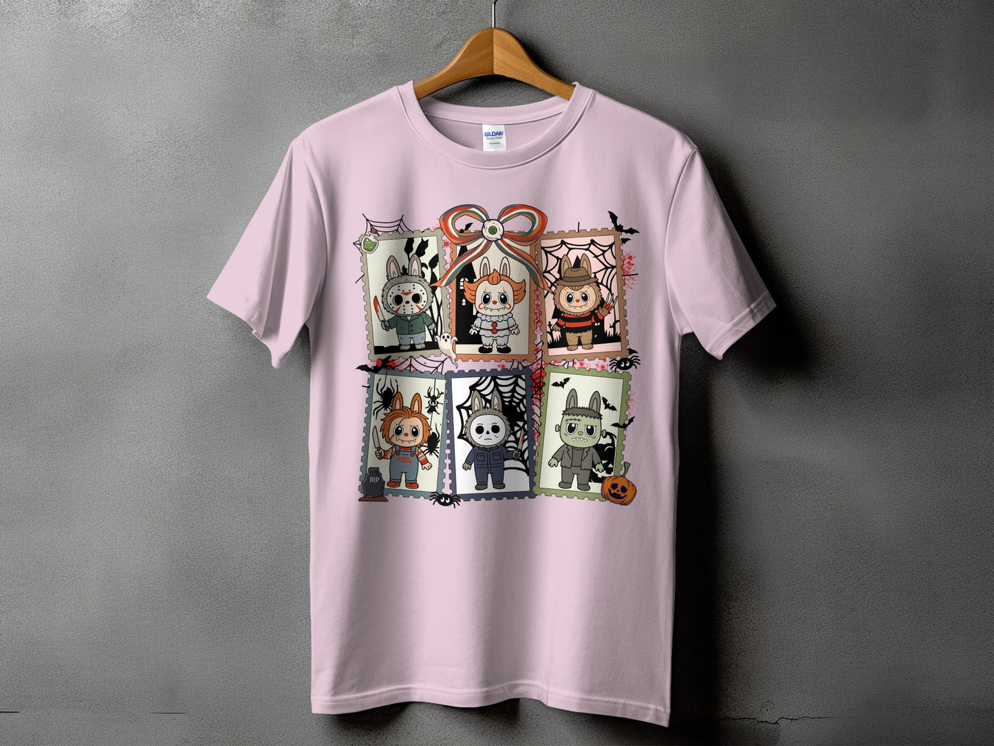 Pink t-shirt with six postage stamps featuring cartoon horror characters for Halloween.