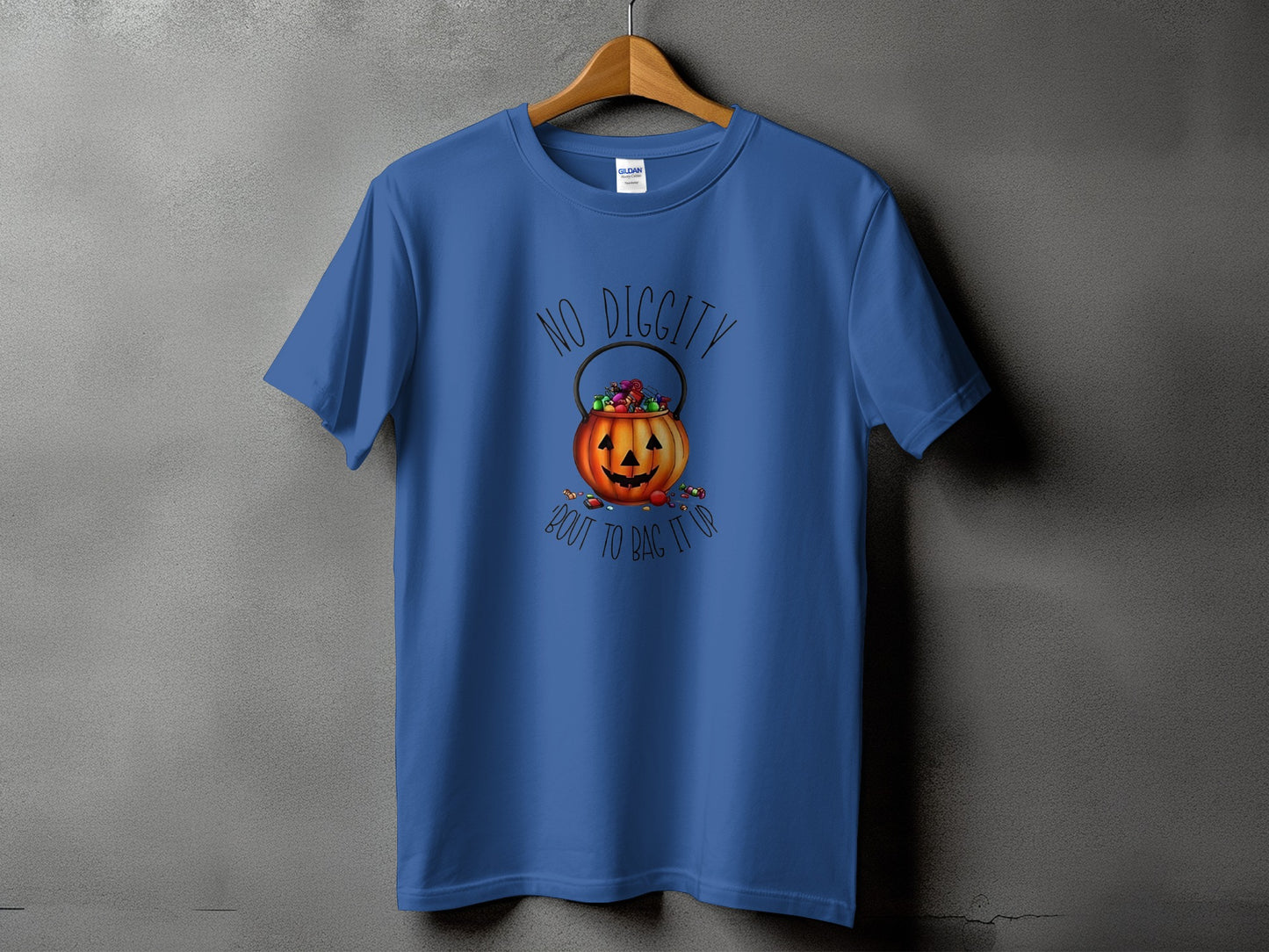 Blue t-shirt with a pumpkin candy bucket graphic and text.