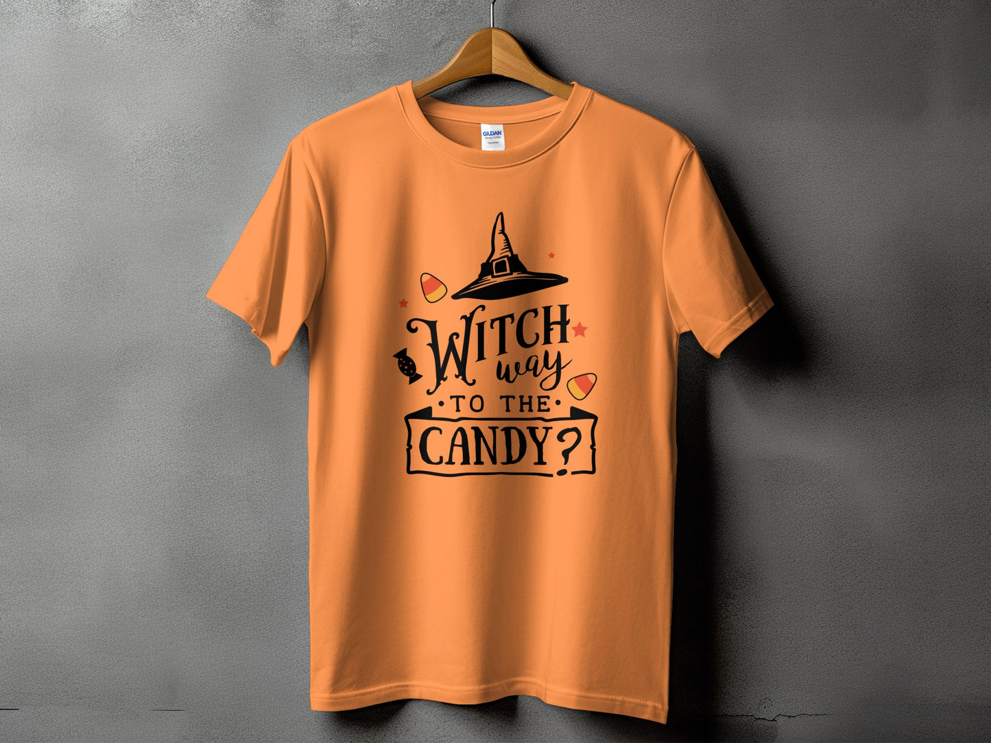 Orange t-shirt with black text: "Witch way to the candy?"