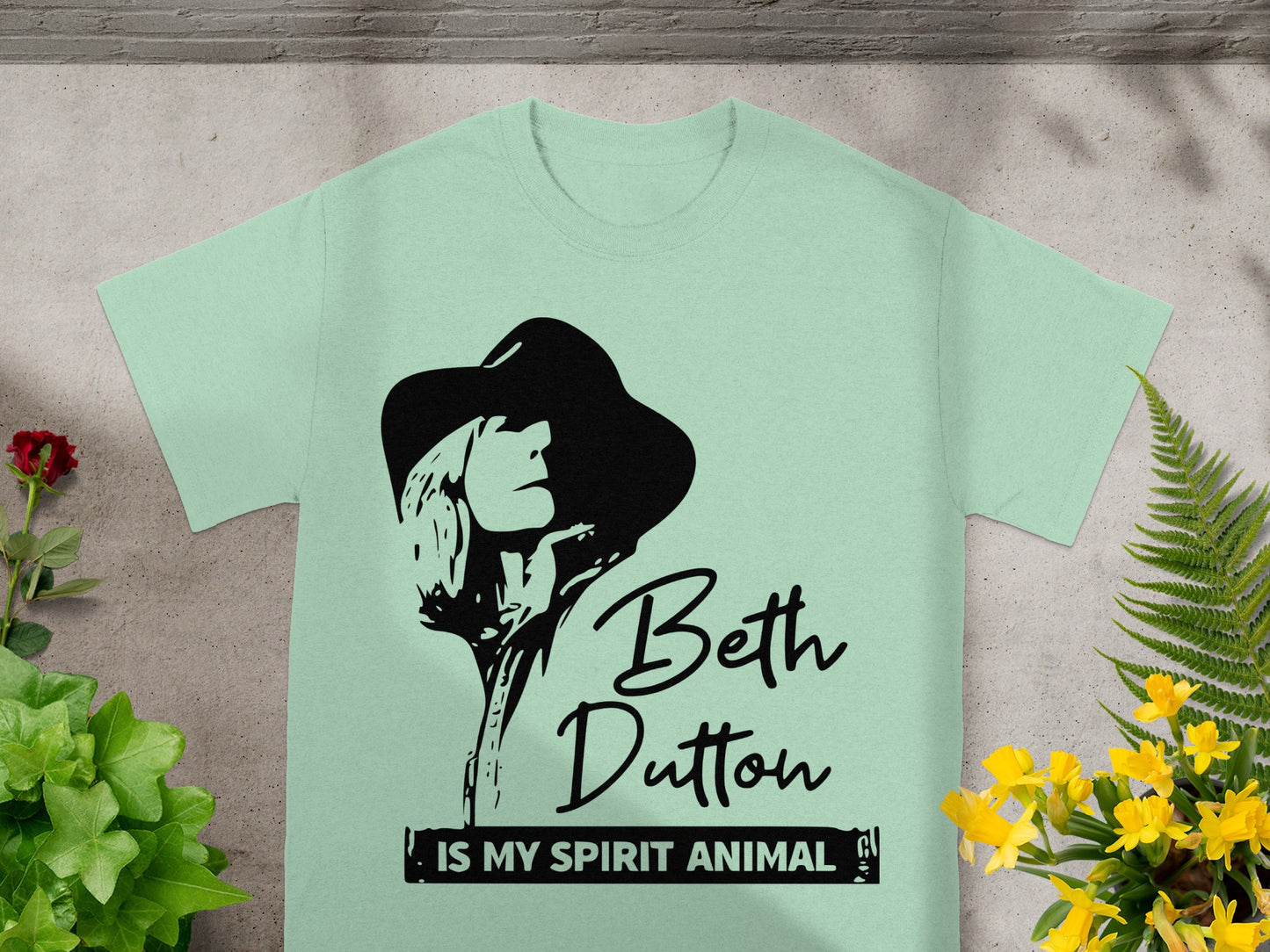 Mint t-shirt with black graphic of Beth Dutton and text "Beth Dutton is my spirit animal".