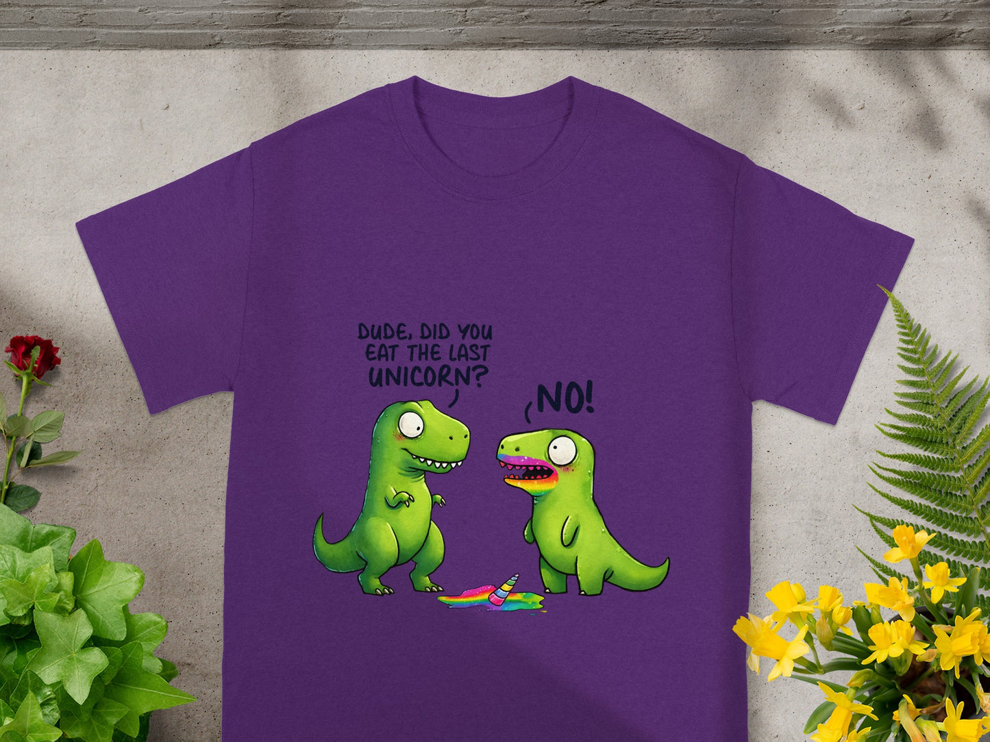 Purple t-shirt with cartoon dinosaurs, one asking "Dude, did you eat the last unicorn?"