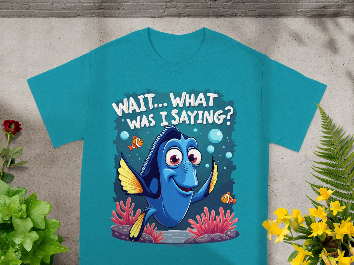 Dory from Finding Nemo on a teal t-shirt saying "WAIT...WHAT WAS I SAYING?".