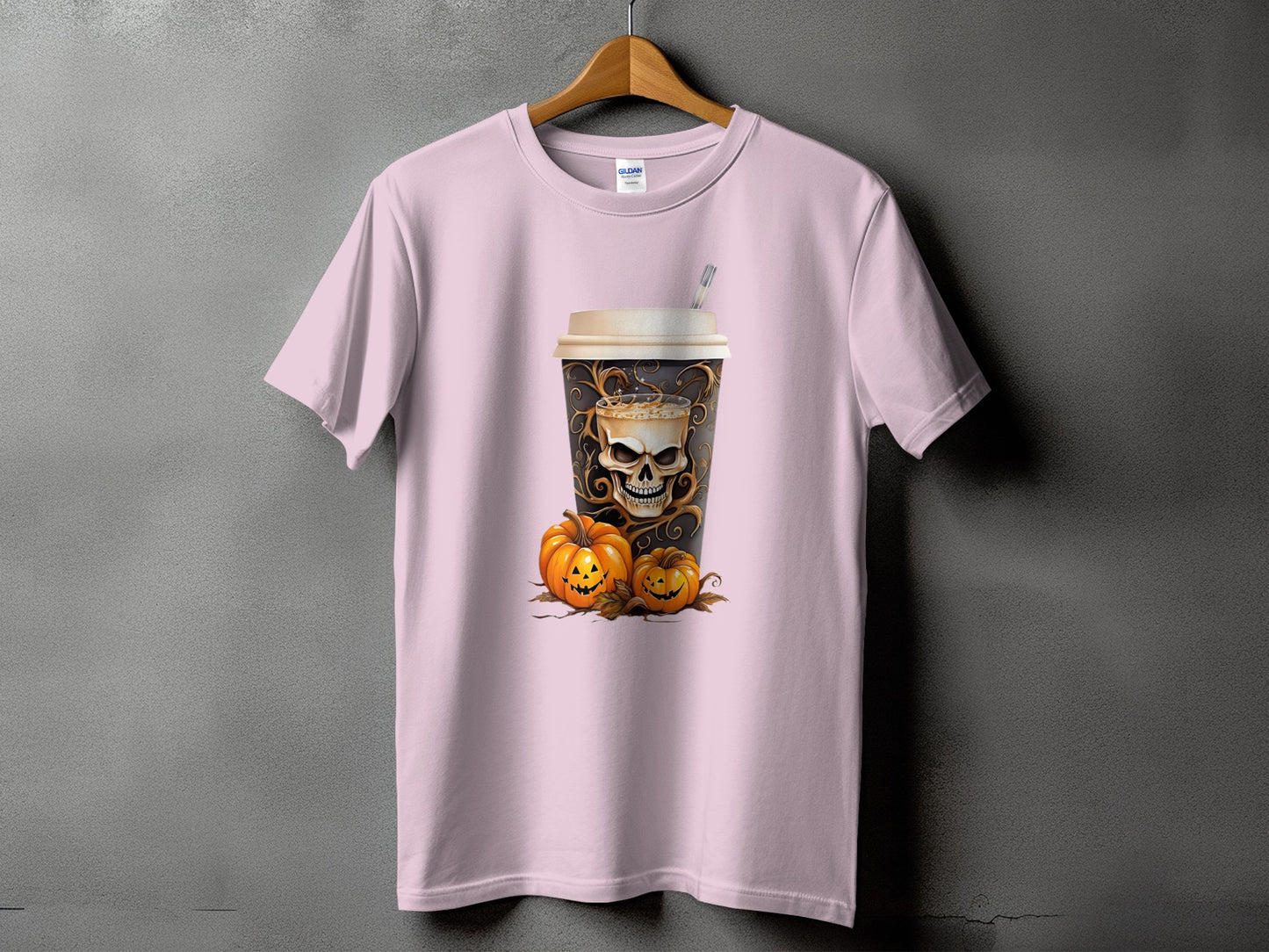 Pink t-shirt with a coffee cup featuring a skull and pumpkins design.