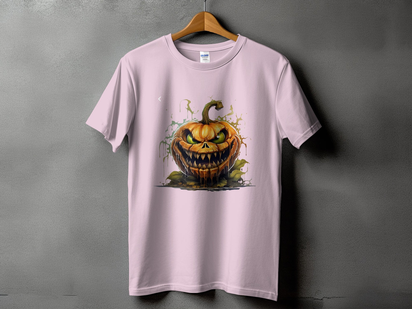 Pink t-shirt with a scary Jack-o'-lantern graphic and green dripping accents.