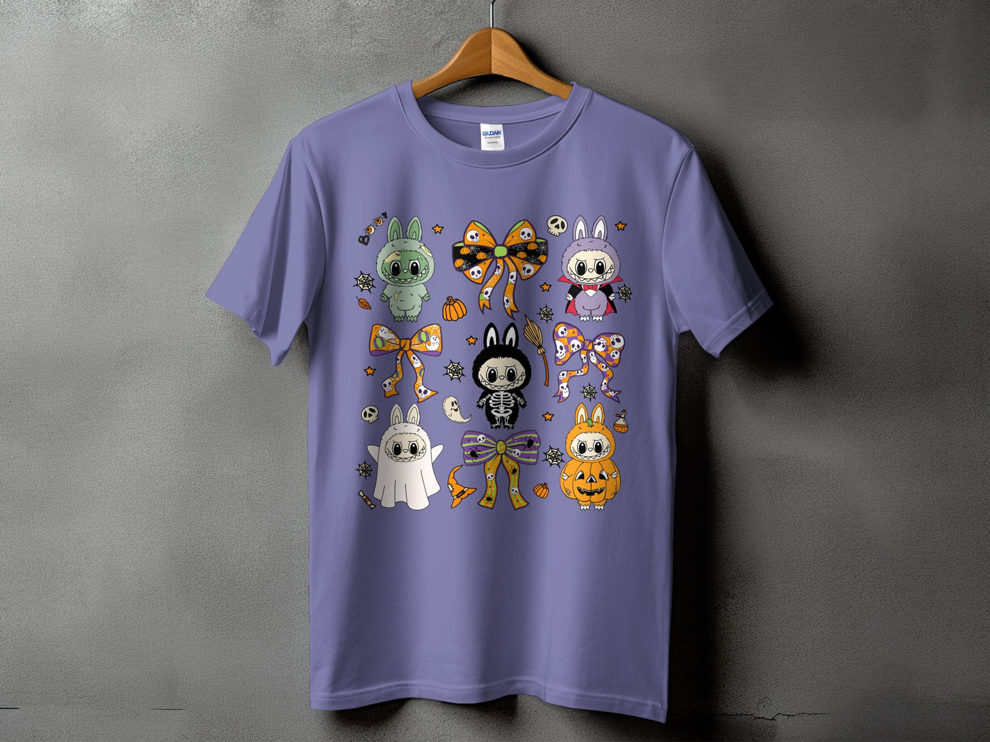 Purple t-shirt with a collage of cute Halloween characters and bows.