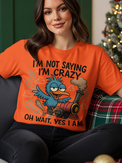 Orange t-shirt with cartoon blue bird on a train, text reads "I'm not saying I'm crazy, oh wait, yes I am".
