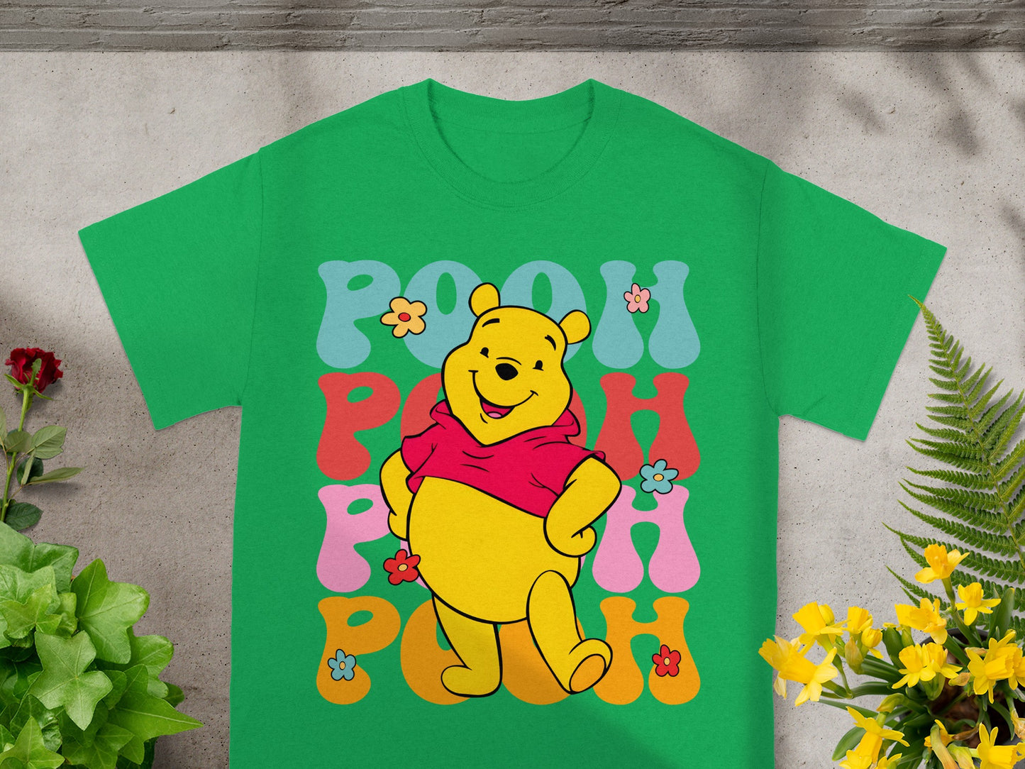 Winnie the Pooh graphic on a green t-shirt.