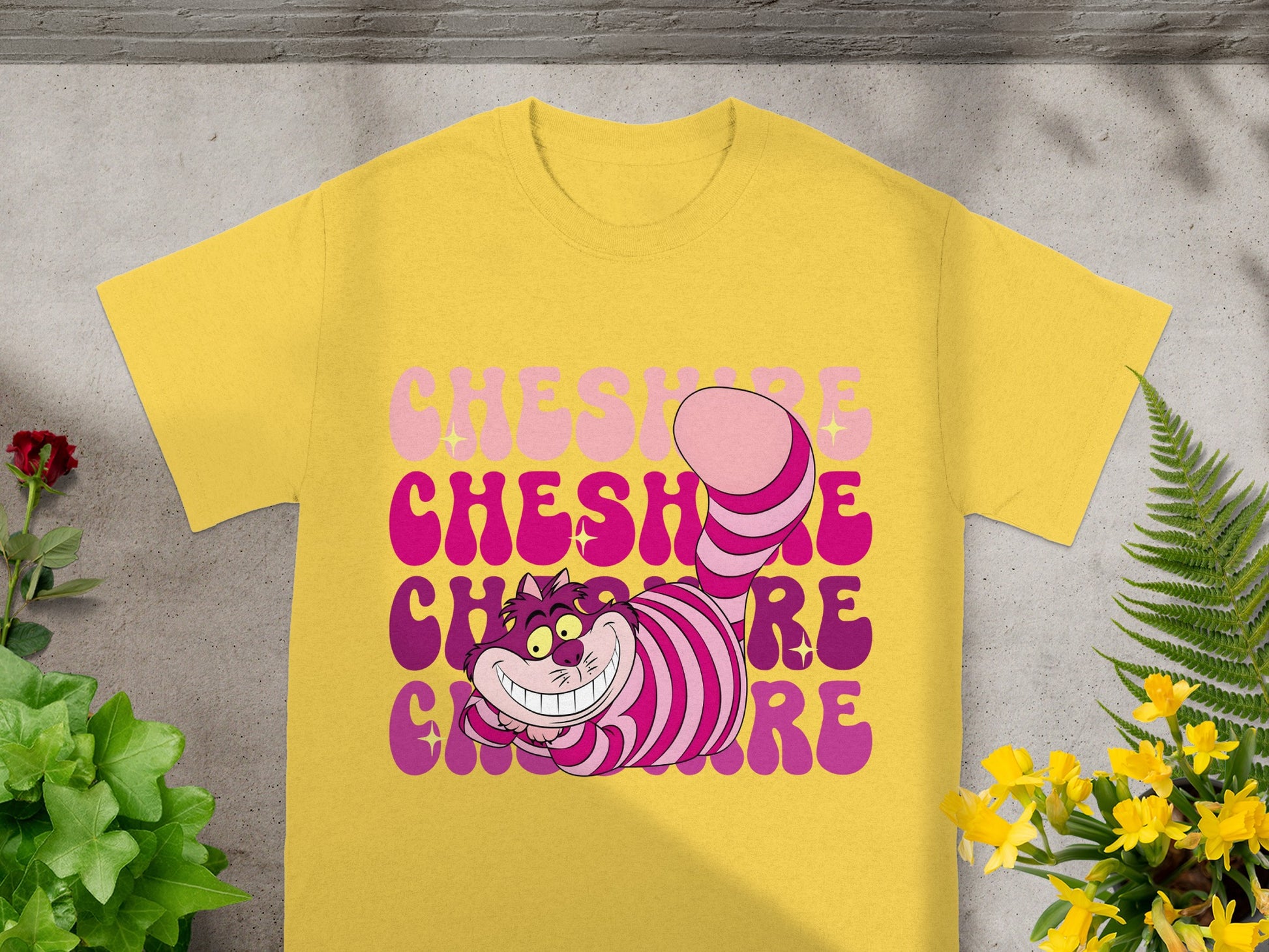 Yellow t-shirt with "Cheshire" in pink and purple gradient text.