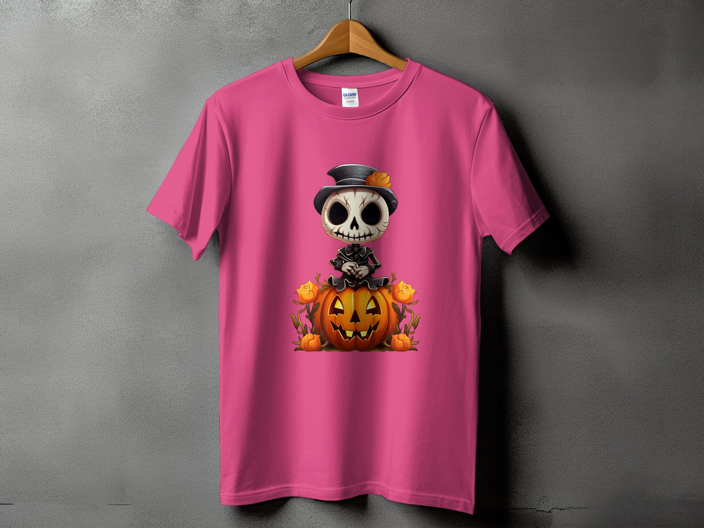 Pink t-shirt with skeleton character sitting on a jack-o'-lantern with roses.