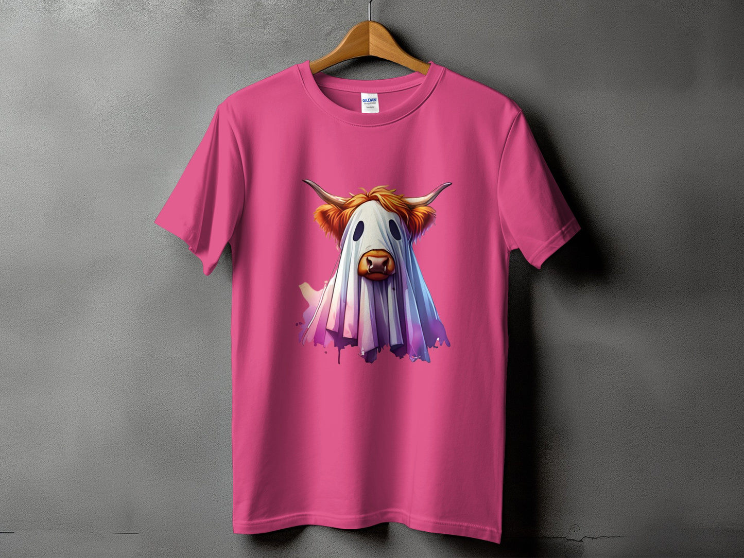 Pink t-shirt with a Highland cow dressed as a ghost illustration.