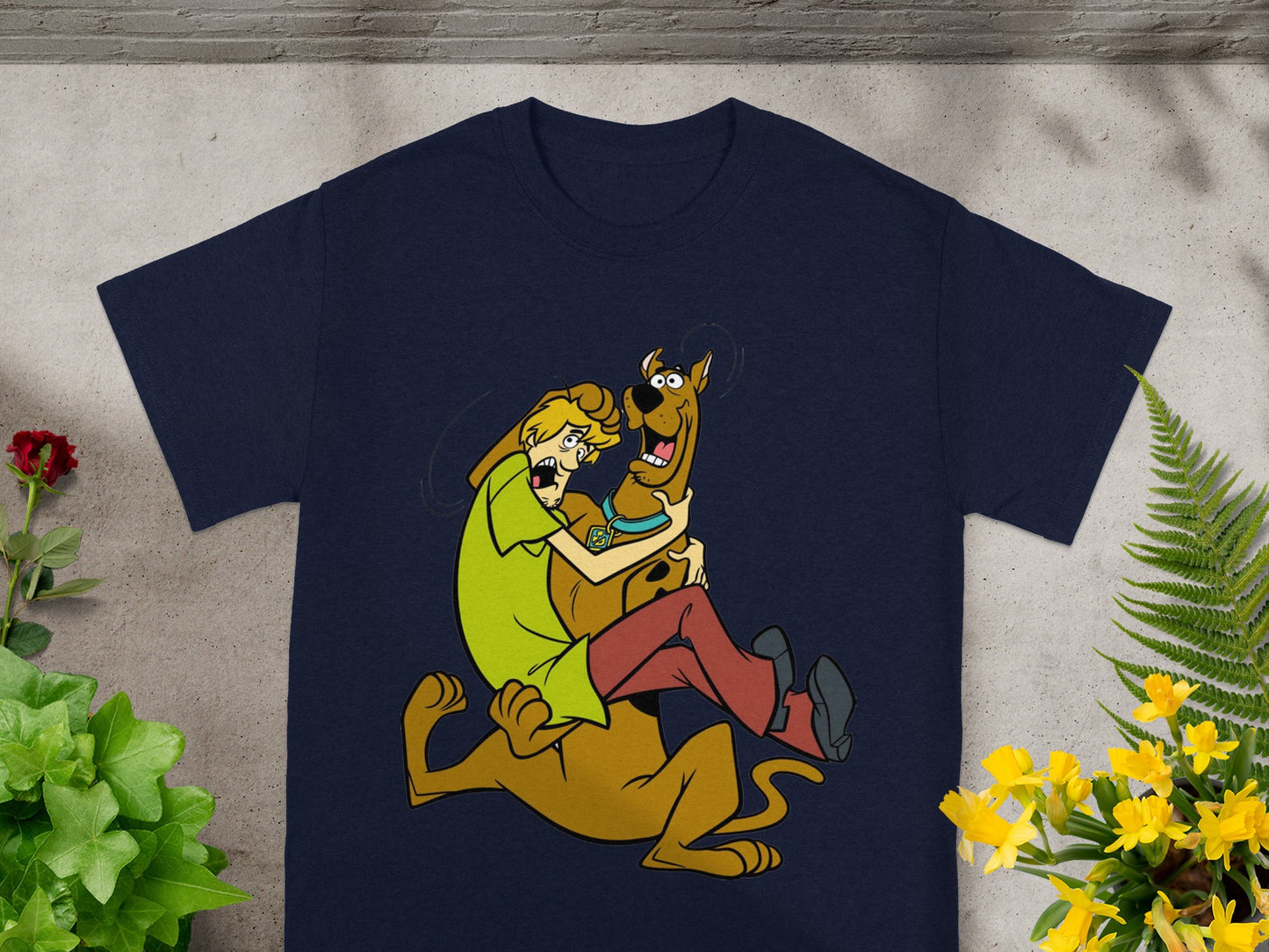Scooby-Doo and Shaggy embrace on a navy t-shirt design.