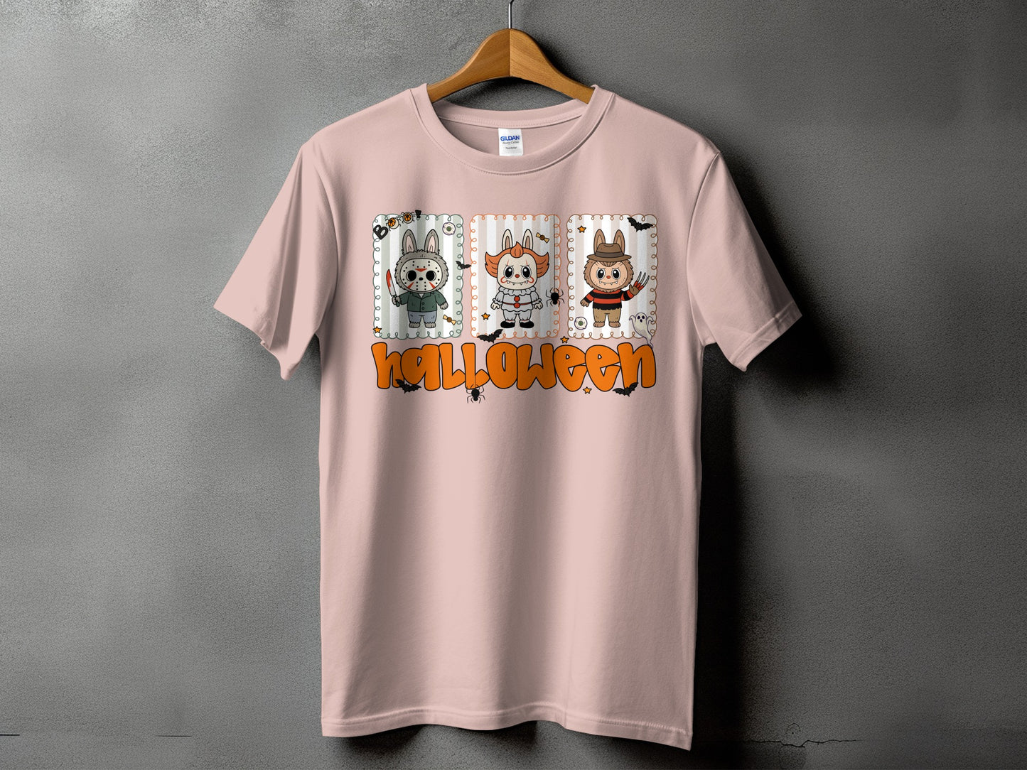 Pink t-shirt with cartoon Halloween characters and the word "Halloween."