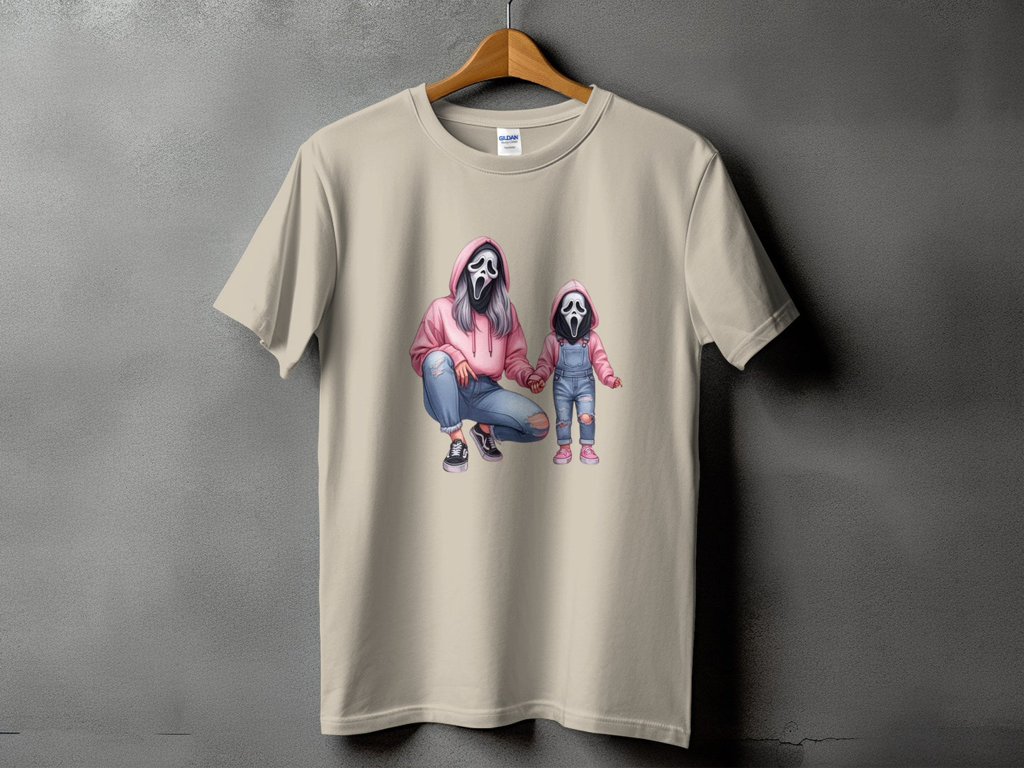 T-shirt with graphic of mother and child wearing ghost masks and pink hoodies.