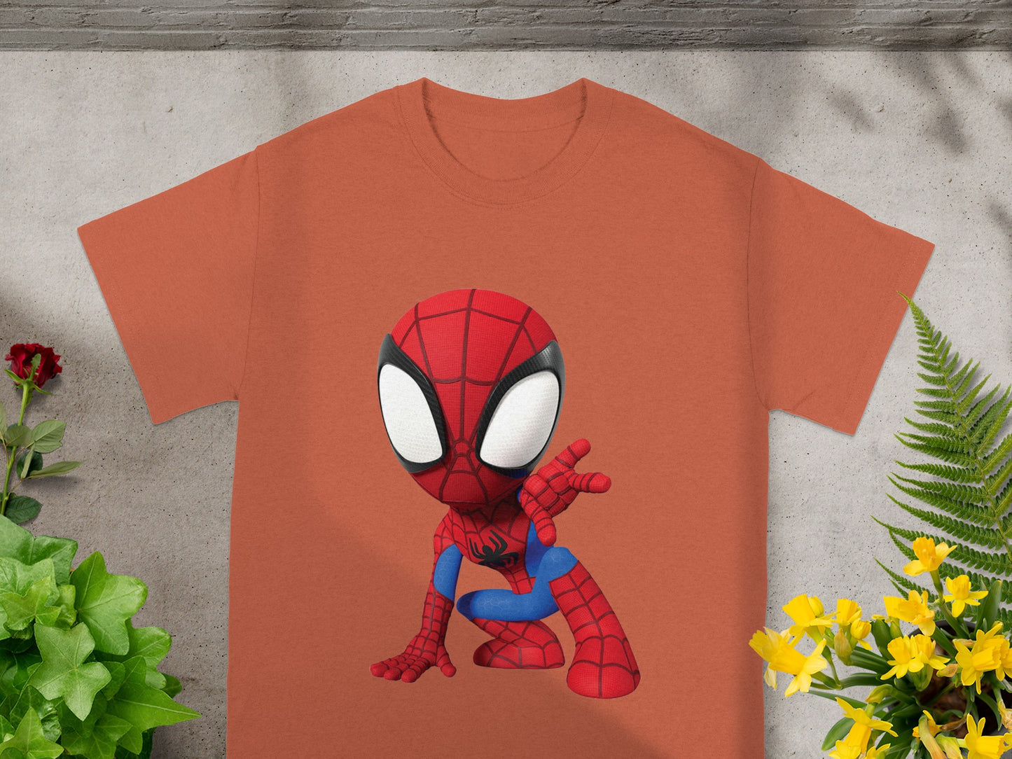 Chibi Spider-Man graphic on an orange t-shirt with plants.