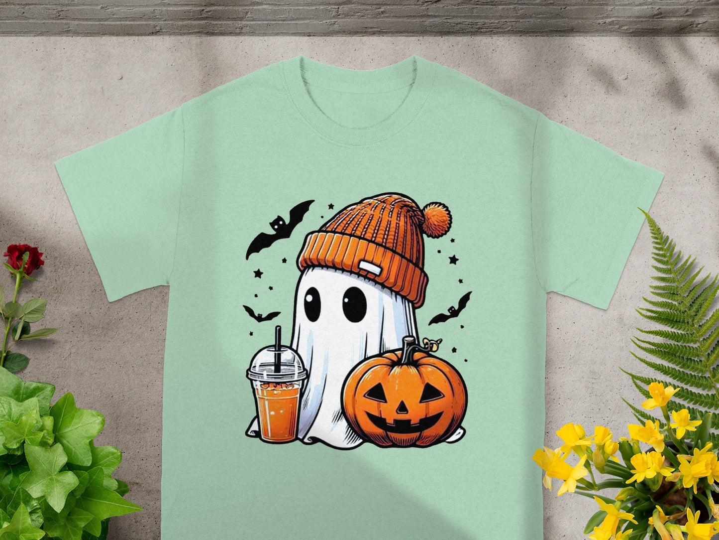Ghost with pumpkin and drink on t-shirt, surrounded by bats and stars.