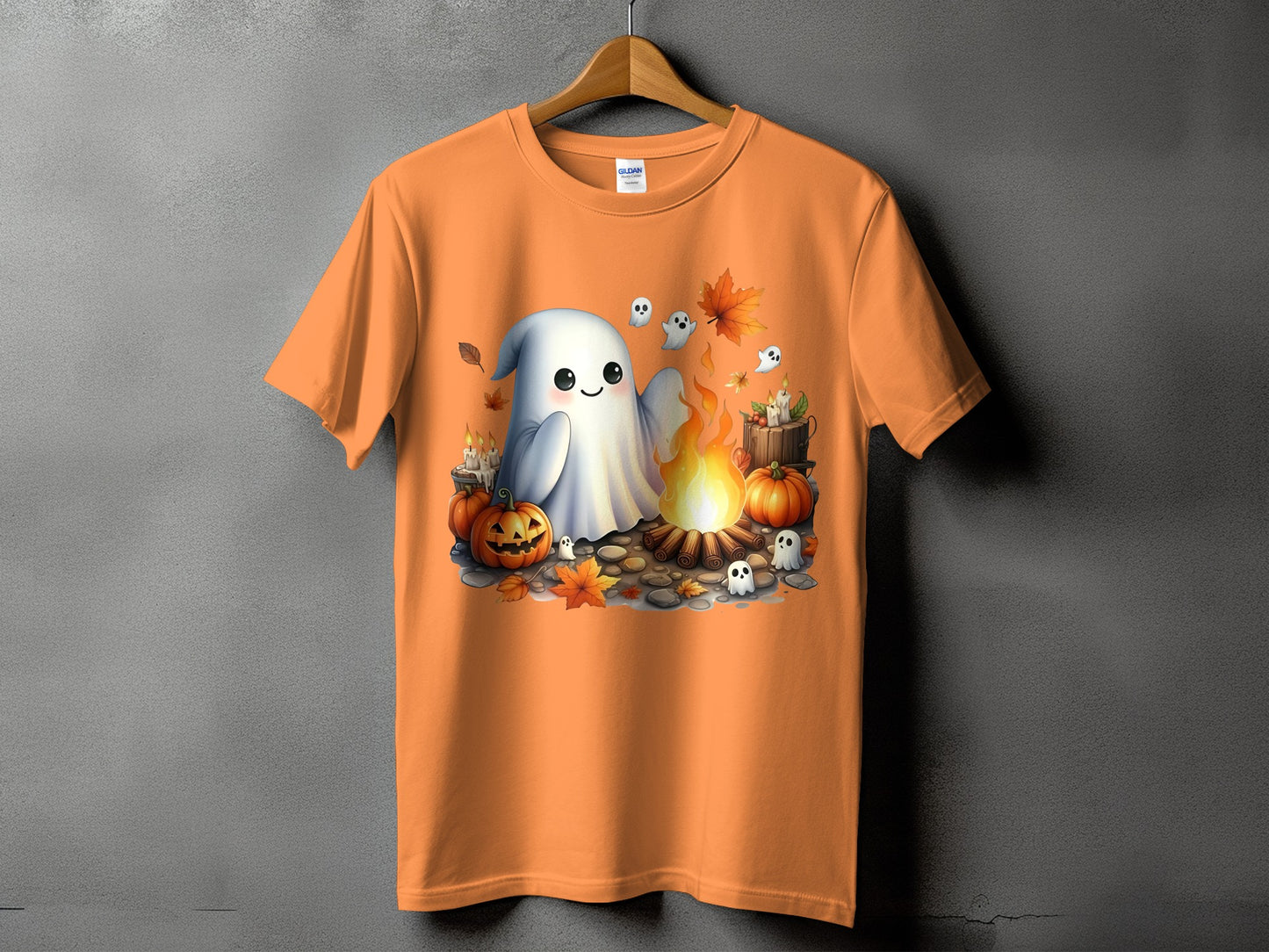 Orange t-shirt with a Halloween graphic of ghosts, pumpkins, and a campfire.