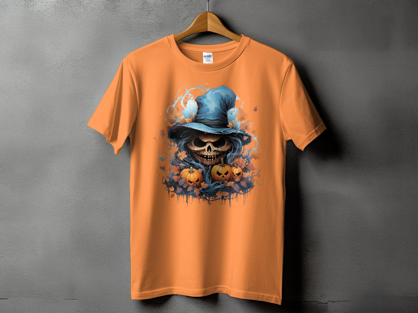 Orange t-shirt with a skull wearing a witch hat and pumpkins graphic.
