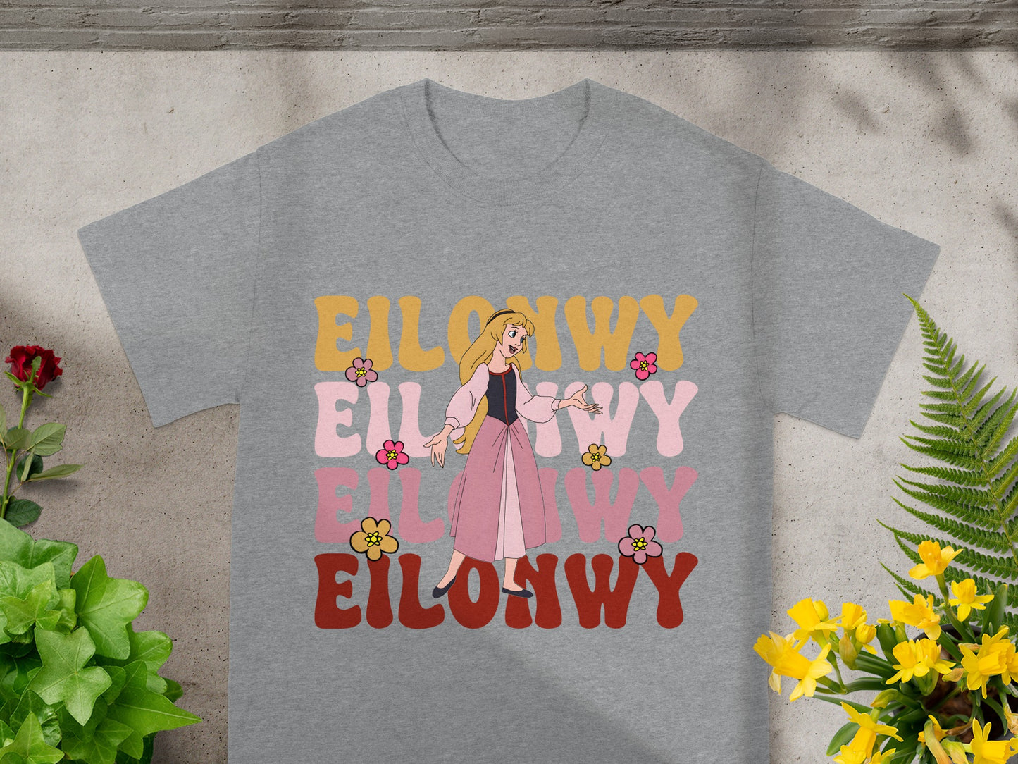 Gray t-shirt with "Eilonwy" in retro colorful letters and a cartoon princess.