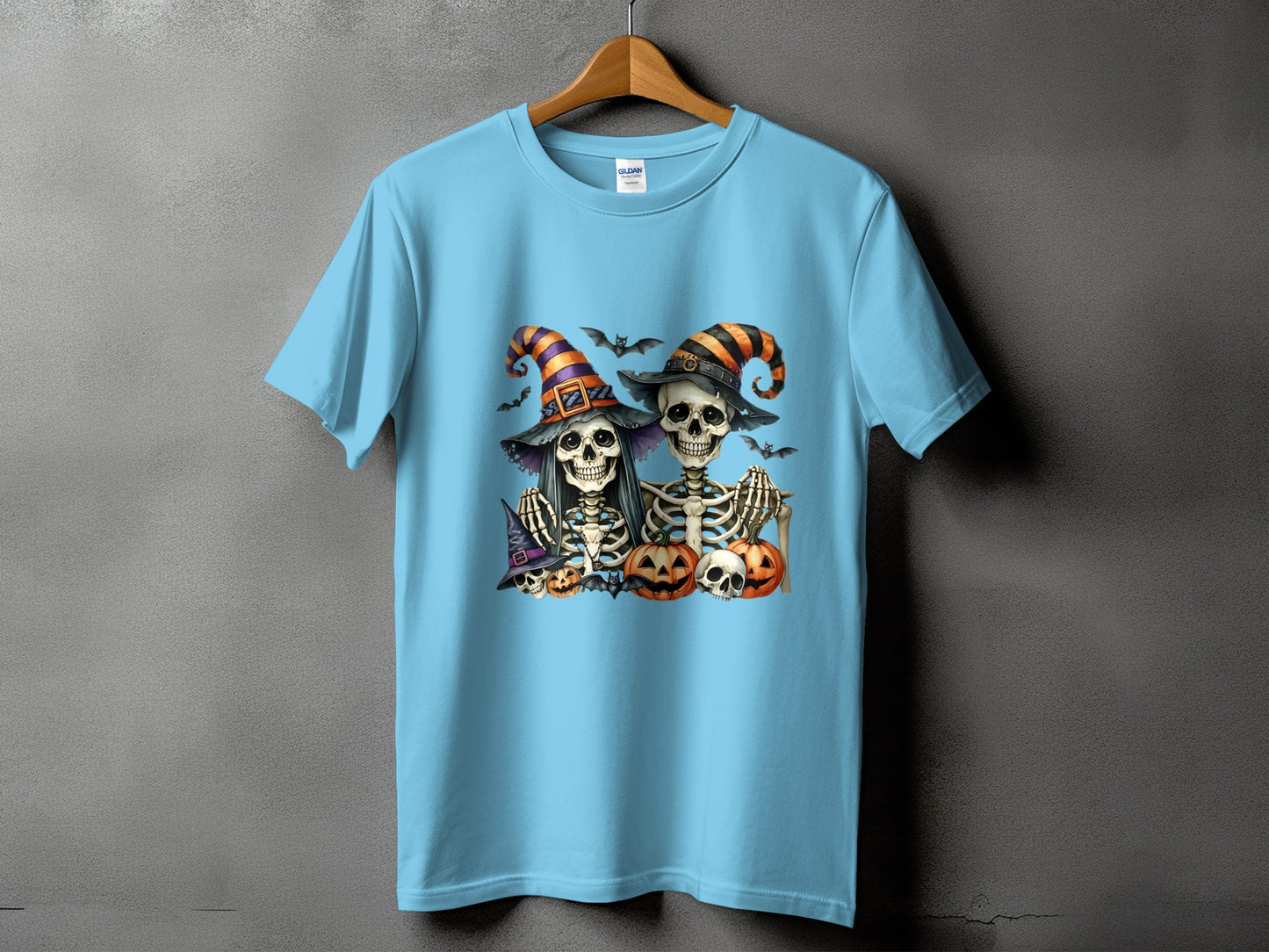Light blue t-shirt with Halloween skeleton graphic and pumpkins.